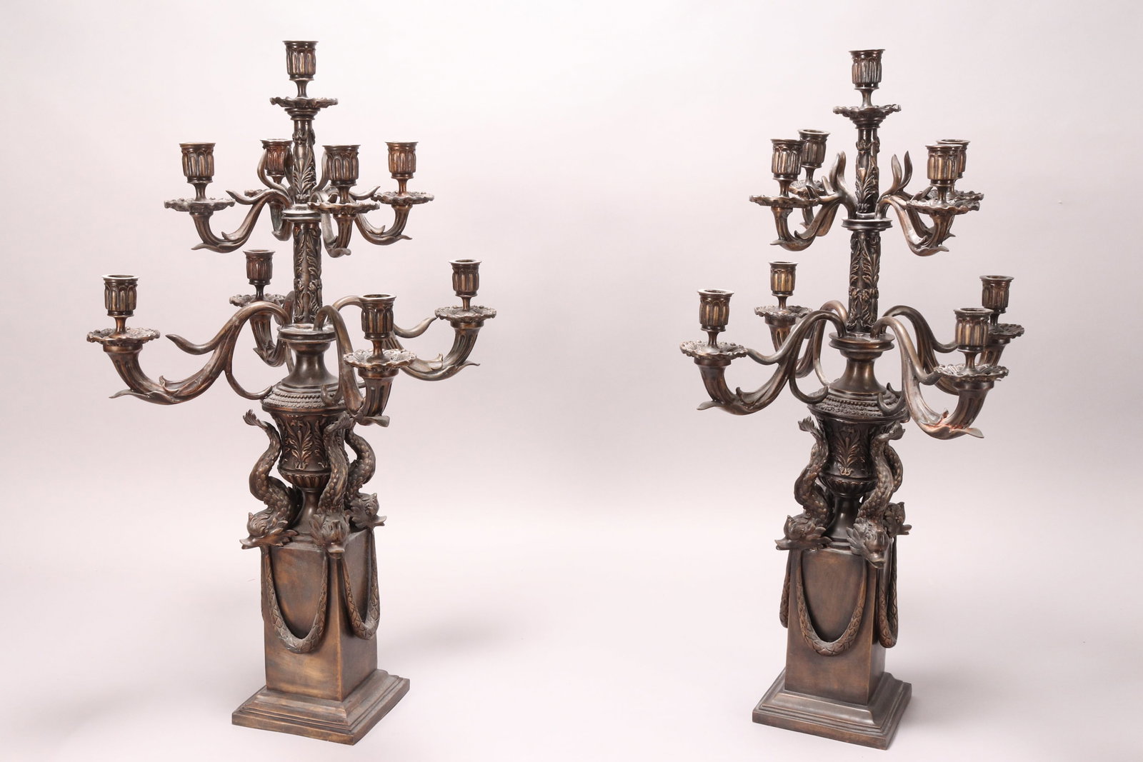 Large Pair of Italian Eight Branched Candelabra,: with a central sconce, surrounded by four larger acanthus branched sconces and four smaller acanthus branched sconces, supported on the backs of four classical dolphins, above a pedestal base, with dr