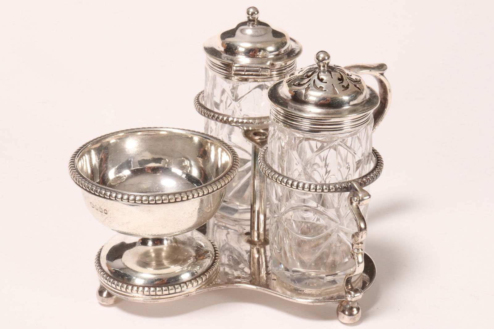 Victorian Sterling Silver Cruet Set,: hallmarked London, 1861, GF (George Fox), comprising an open (not including silver topped items), height 9cmsalt, pepper shaker and condiment jar, set with stylised handle and stylised struts, decorat