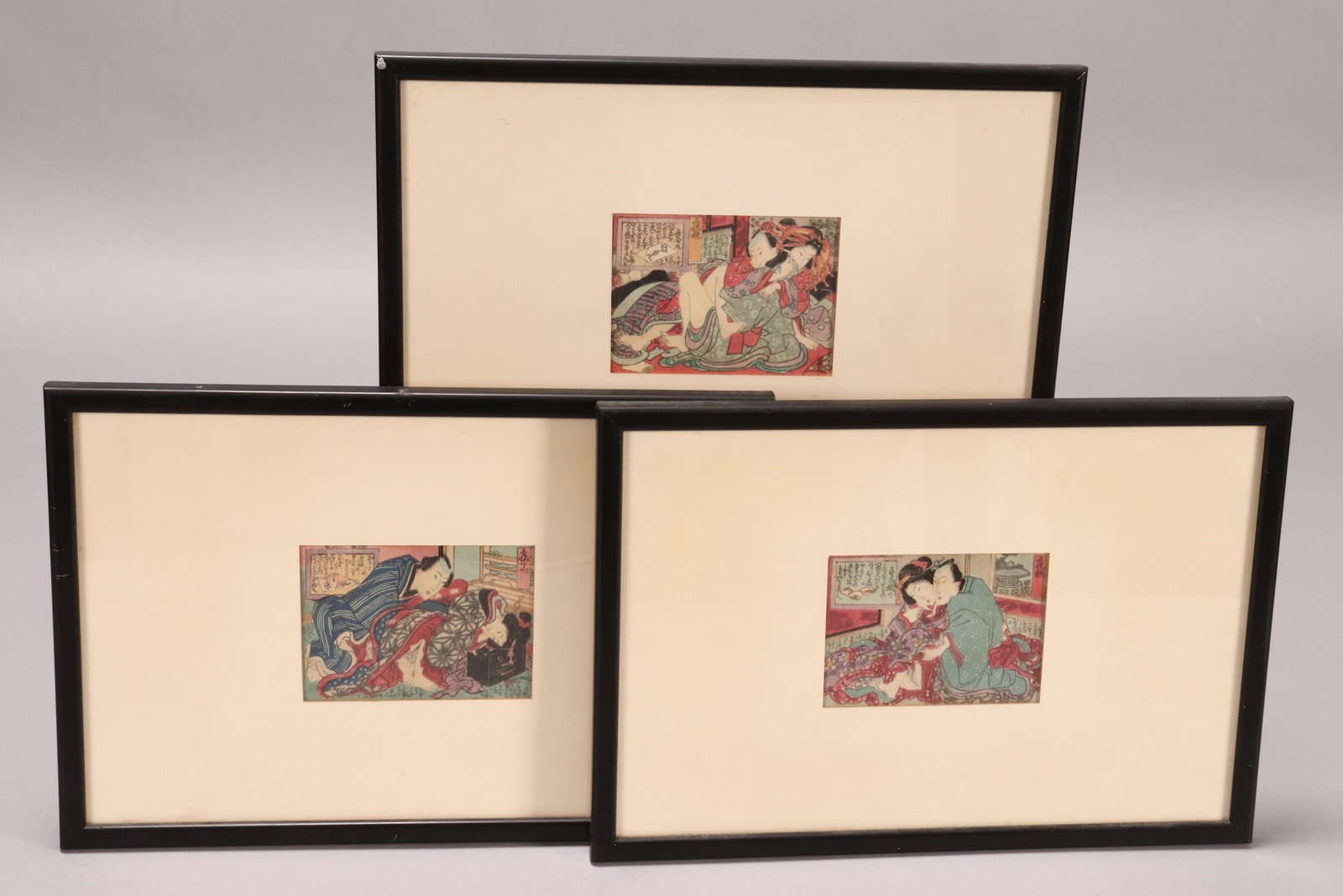 Three Japanese Meiji Period Shunga Prints,: Utagawa school, each with catalogue label verso, purchased from The Japanese Gallery, C.D Wertheim London', 8.5cm x 12cm and 24.5cm x 36.5cm (frame) (3)