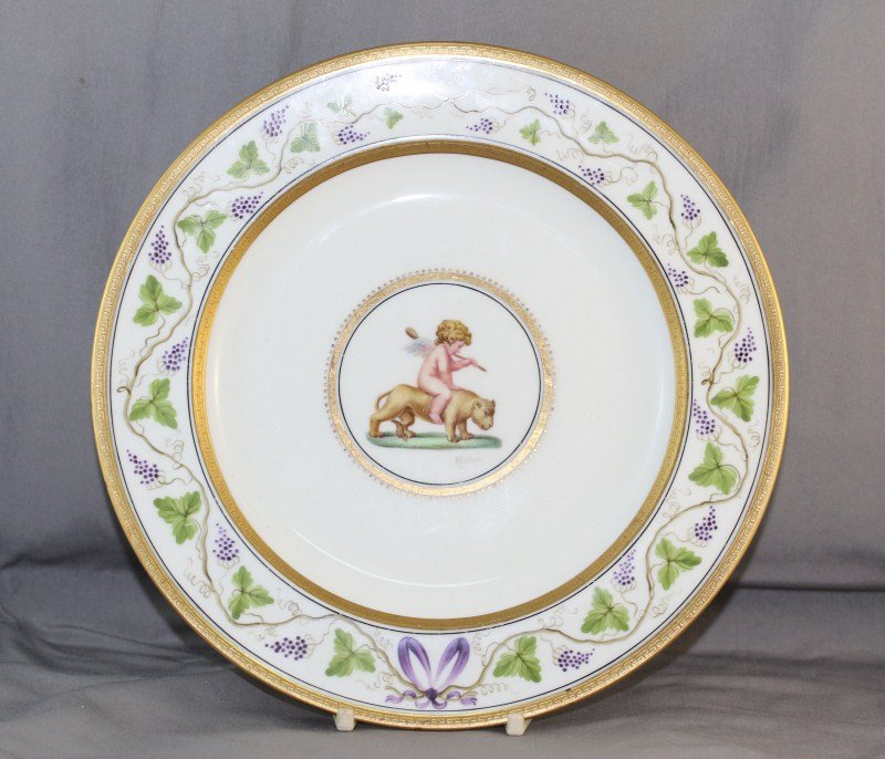 Rare Wedgwood Cabinet Plate,: made for Thomas Webb & Sons, Melbourne, painted with central roundel of cupid riding a lion cub, signed A. Holland, surrounded by a grape vine boarder and raised gilt work, d 22.5cm