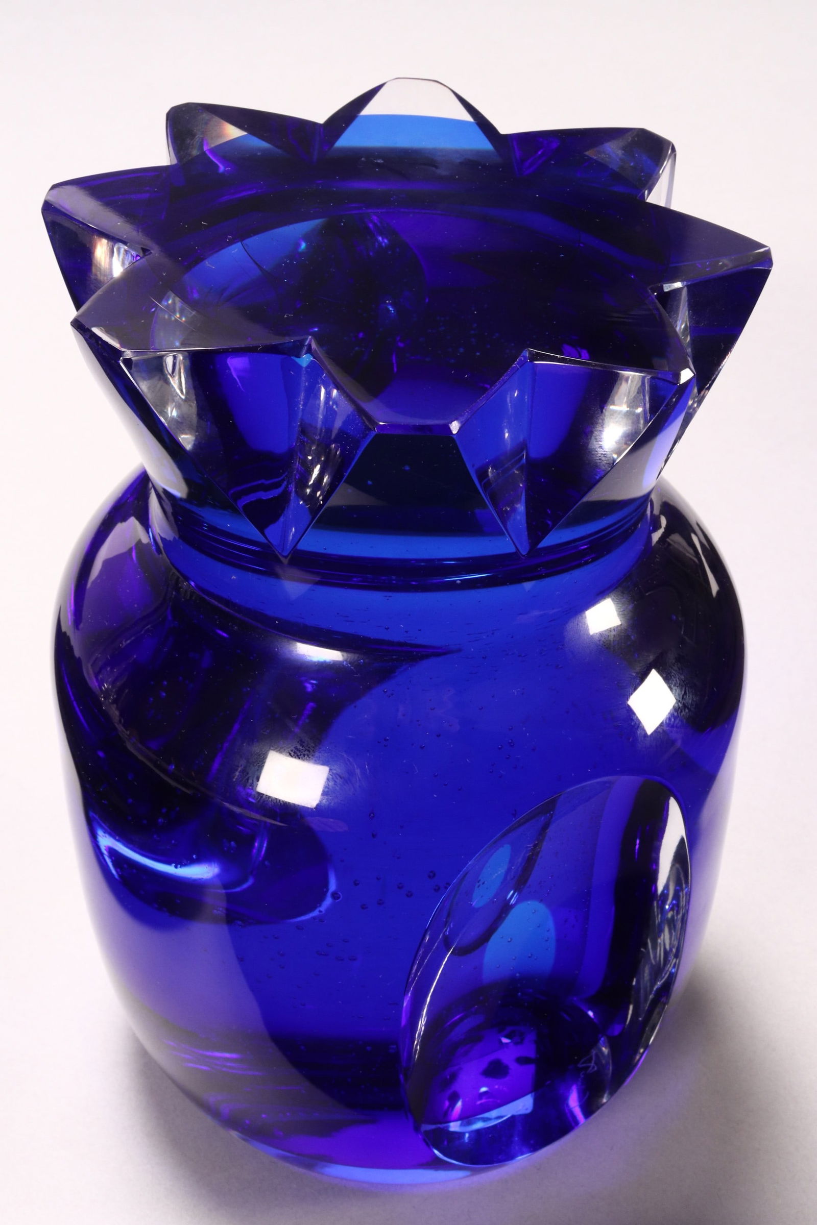 Goran Warff (1933-2022) Glass Pineapple,: for Kosta Boda Unique, in blue glass with two facetted edges, set with a clear glass spy hole too see through the piece, etched Goran Wariff x 2, Kosta Boda Unique, 7248086, with original paper label,