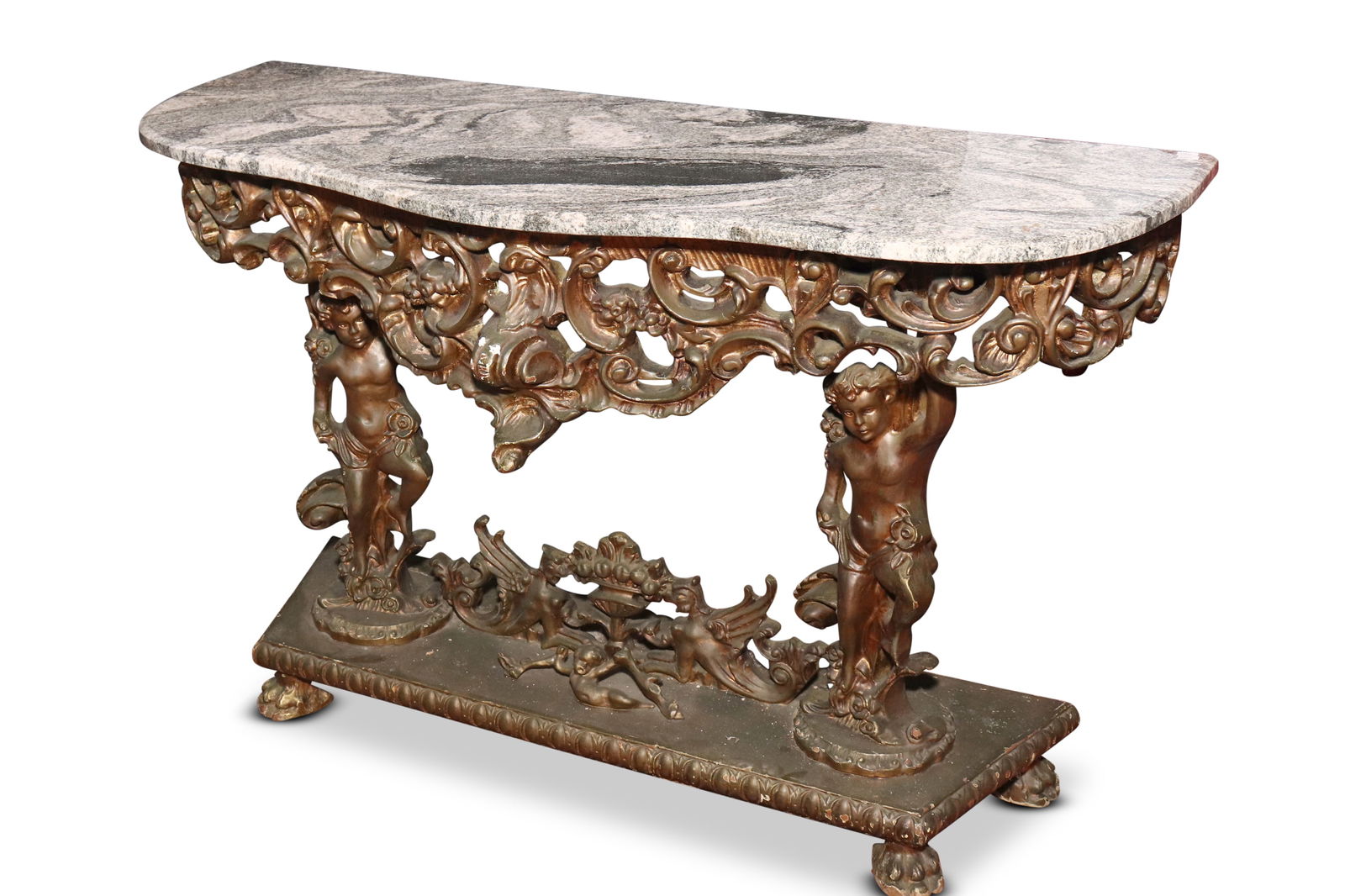 Italian Baroque Style Marble Top Console Table,: with a shaped marble top, above an ornate and pierced apron displaying c-scrolls and floral motifs, supported on putto with lower medallion, 79cm x 126cm x 44cm