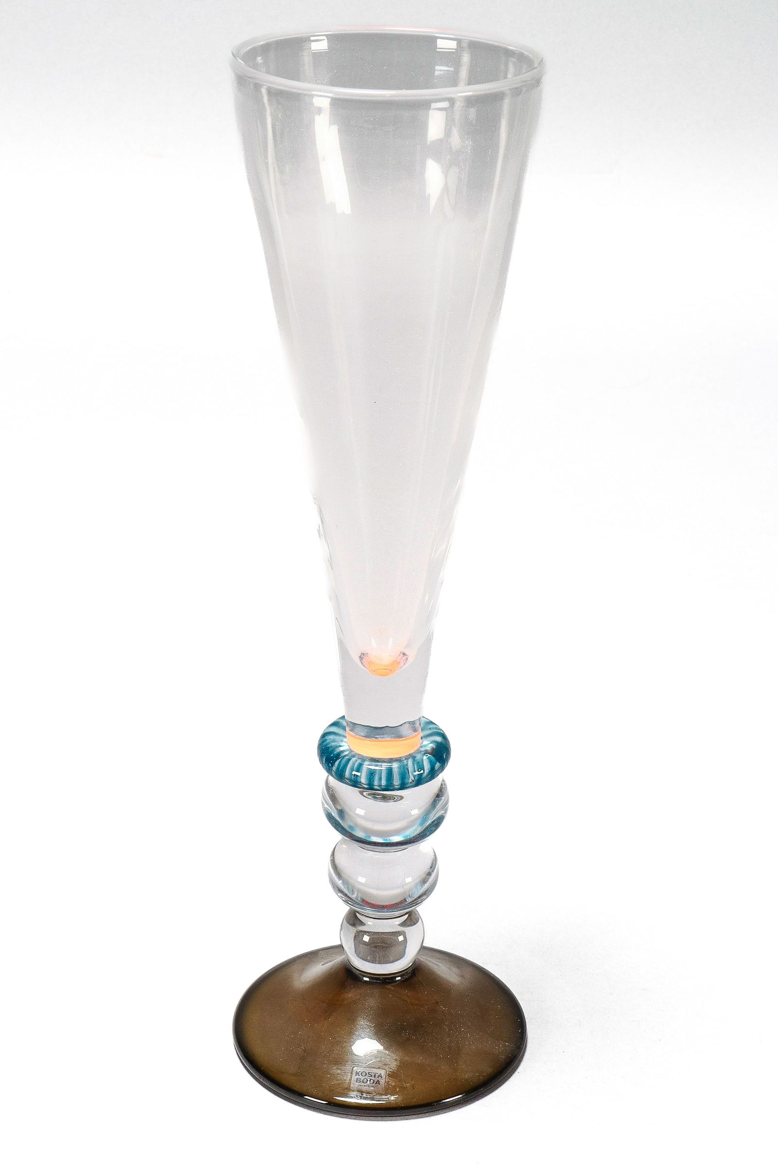 Goran Warff (1933-2022) Contemporary Glass Goblet,: for Kosta Boda, of tapering form, set with a gourd stem on a spreading foot, in blue, orange, brown and clear glass, etched 7239010, Kosta Boda, Lim.Ed 30, Goran Warff, with original label, height 34c