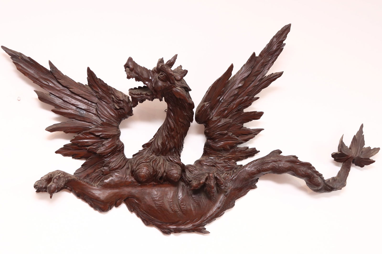 Large 19th Century Italian Carved Finial,: in the form of a winged dragon with head to the left, flanked by wings, tail and claws, a/f, length 134cm