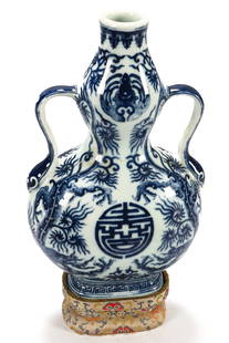 Good Chinese Twin Handled Double Gourd Vase,: in blue and white porcelain, decorated with rampant dragons, bats, shou symbols and Greek key border, raised on an oval foot, with seal mark to base, on a brocade stand, height 20cm