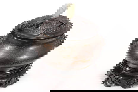 Good Chinese Bronze Censer, Cover and Stand,: the slightly domed wooden cover set with jade finial in the form of buddhas hand citron and carved and pierced with foliate and c-scroll motifs, the censer of squat form with twin mythical beast handl