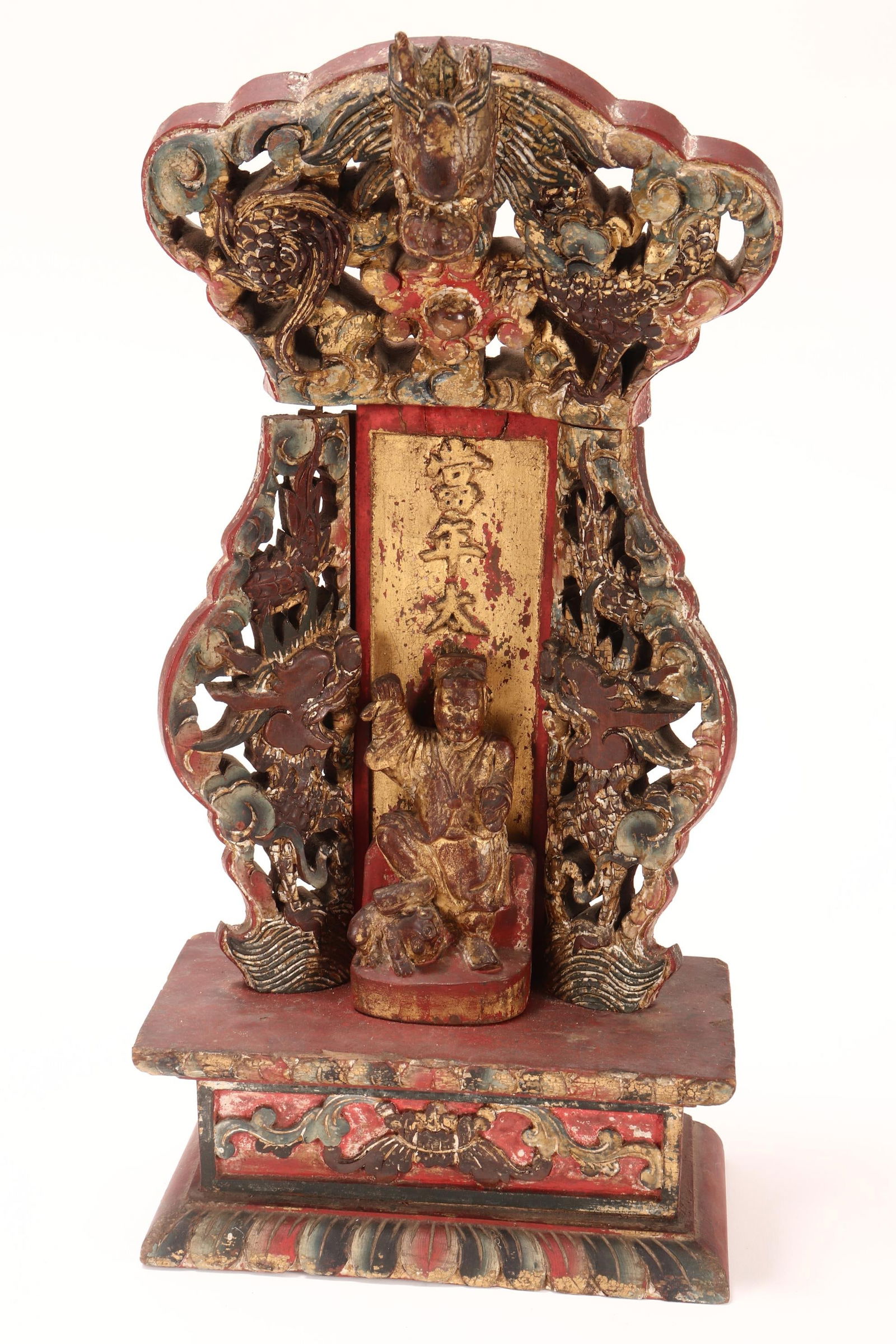 Chinese Late Qing Dynasty Votive Stele and Figure,: the stele carved with upper dragon above a flaming pearl, flanked by dragons to the sides, with central script above figure with guardian dog, on a carved base, in tones of green, red lacquer and gilt