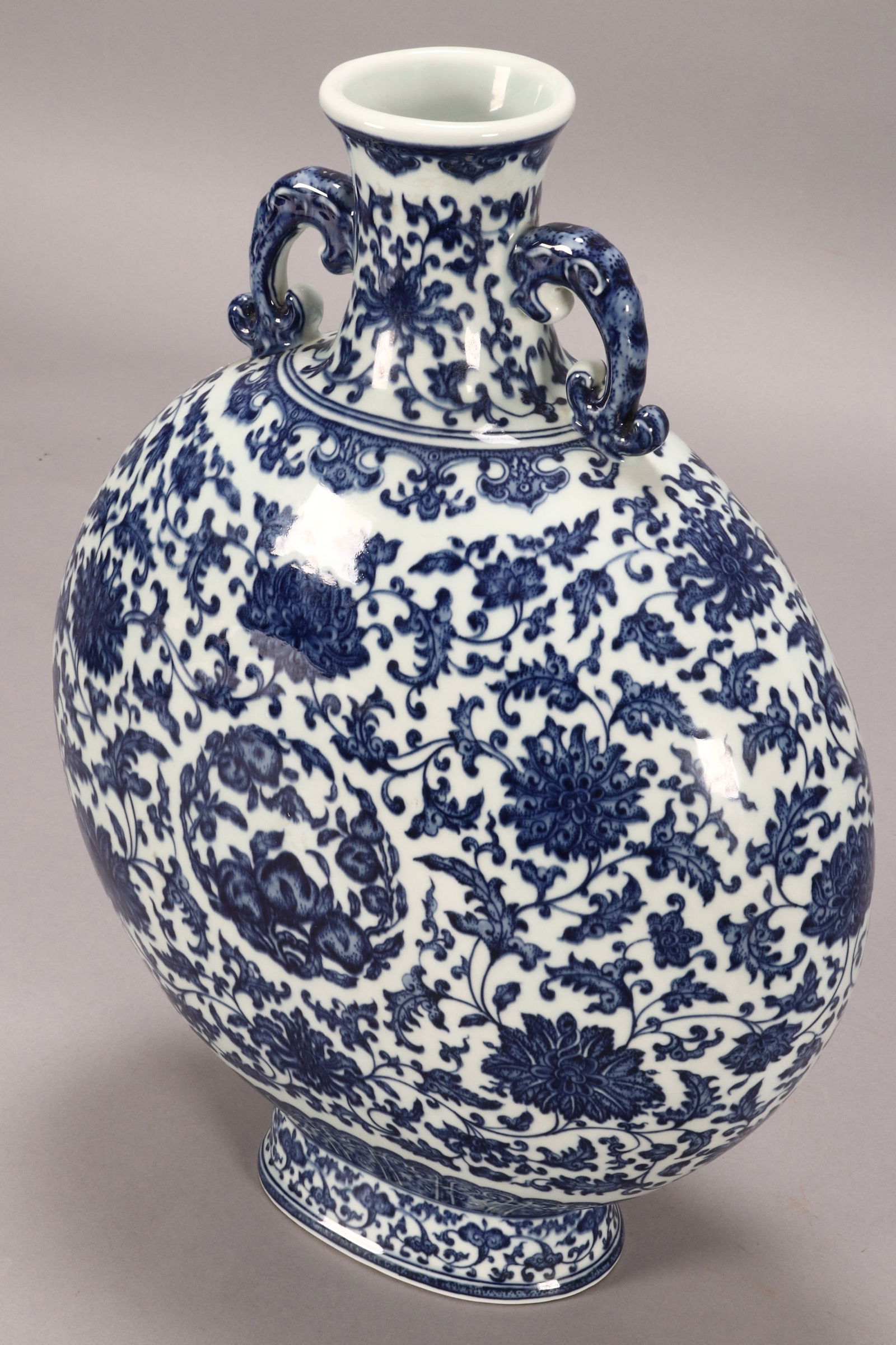Large and Impressive 'Peach Medallion' Moon Flask,: of compressed spherical form, with waisted neck and twin handles, decorated with central medallion containing peaches and foliage, surrounded by lotus scrolls, set with ruyi head borders, in blue and