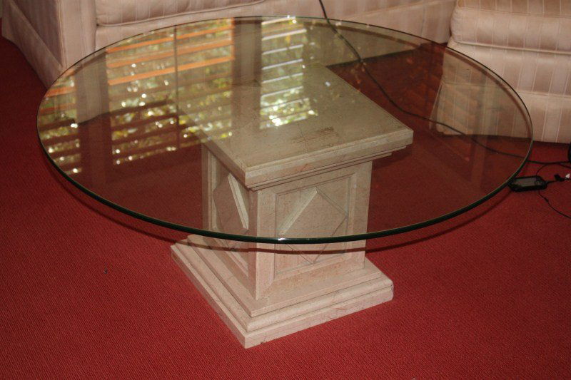 Italian Travertine Glass Top Coffee Table,: set with a circular glass top, supported on a square pedestal base with diamond motifs, h 45cm
