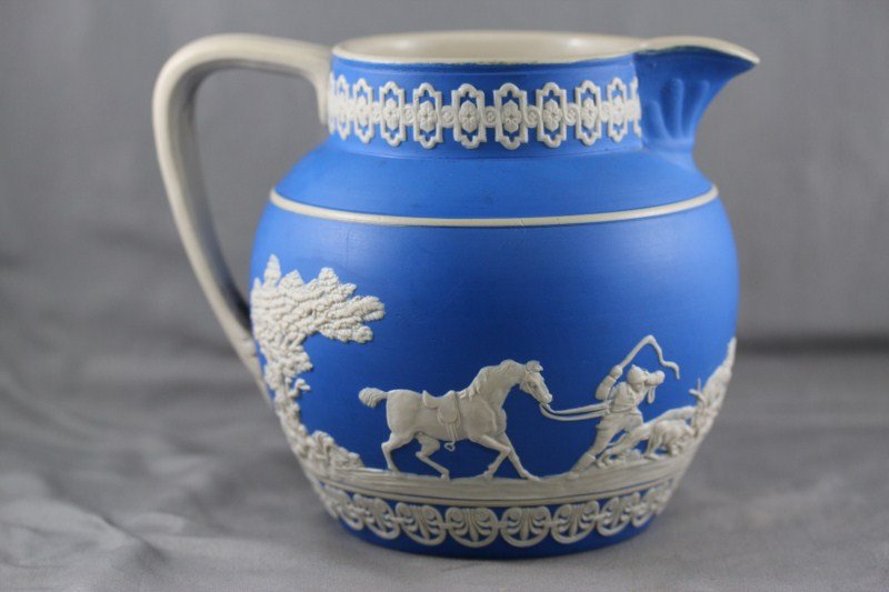 Copeland Spode Jasperware Jug,: of baluster form, decorated with a continuous frieze of horses and figures, in white on a blue ground, h 14cm
