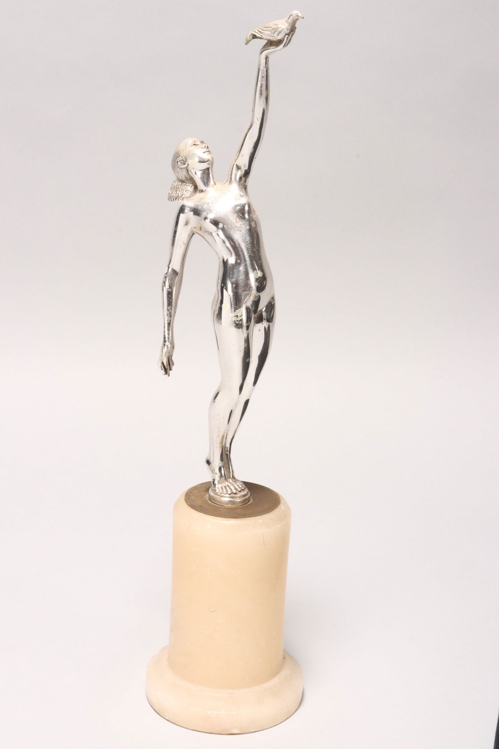 Pierre Le Faguays (French, 1892?1962),: Messager d'amour (Messenger of Love), silvered bronze on onyx base signed 'P. Le Faguays' to base of figure total height 42cm