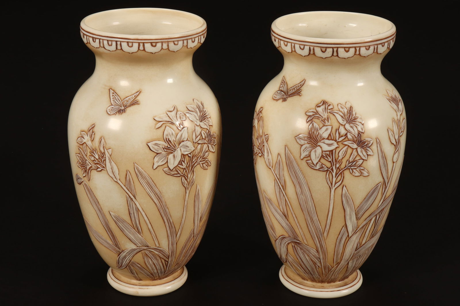 Good Pair of Thomas Webb & Co. 'Ivory' Cameo Glass Vases,: c.1880, of tapering ovoid form, beautifully decorated with a continuous frieze of jonquils and butterflies, in tones of white and cream, raised on a circular foot, makers marks to base, height 21.5cm
