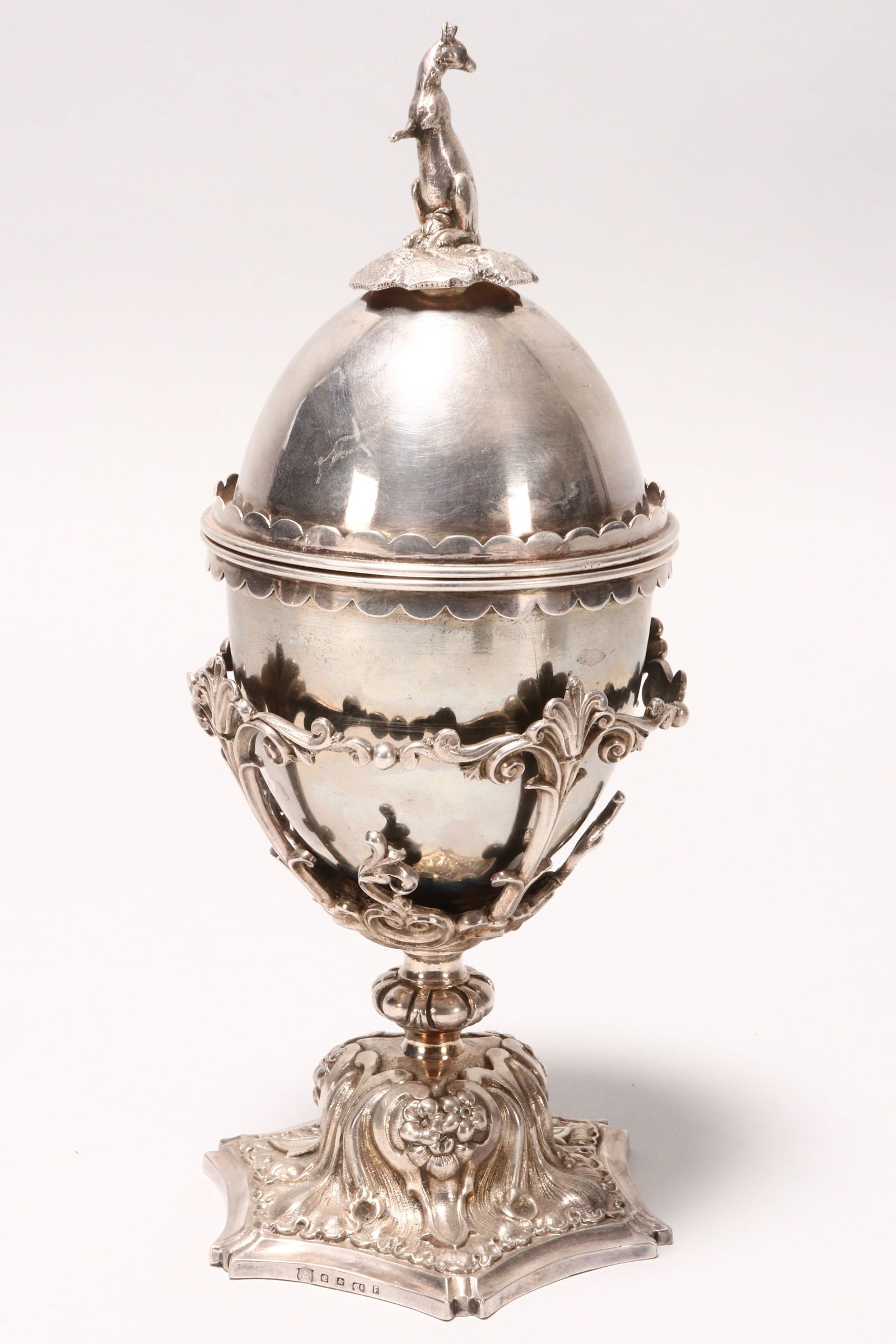 Elkington Silver Plate Cup and Cover,: set with later kangaroo finial, on an egg shaped cover and cup, set within a scrolled and floral stand, height 27cm, Provenance: Private Collection of the Late Derek Greengrass, Antique Dealer