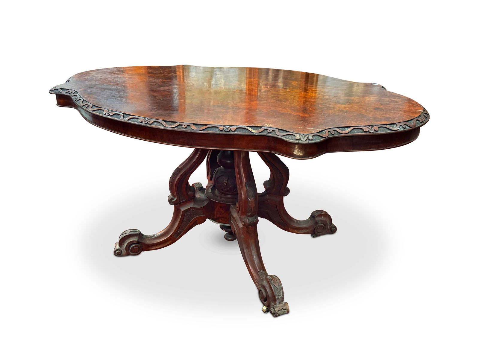 Good Victorian Walnut Centre Table,: with a shaped top with carved border, raised on a birdcage support, on four carved scrolled feet, 78cm x 143cm x 103cm