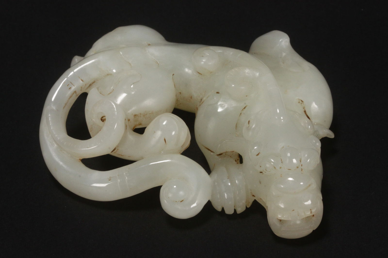 Good Chinese White to Pale Jade Chilong,: with scrolled tale, and curved body with one paw forward, in tones of white, length 8cm