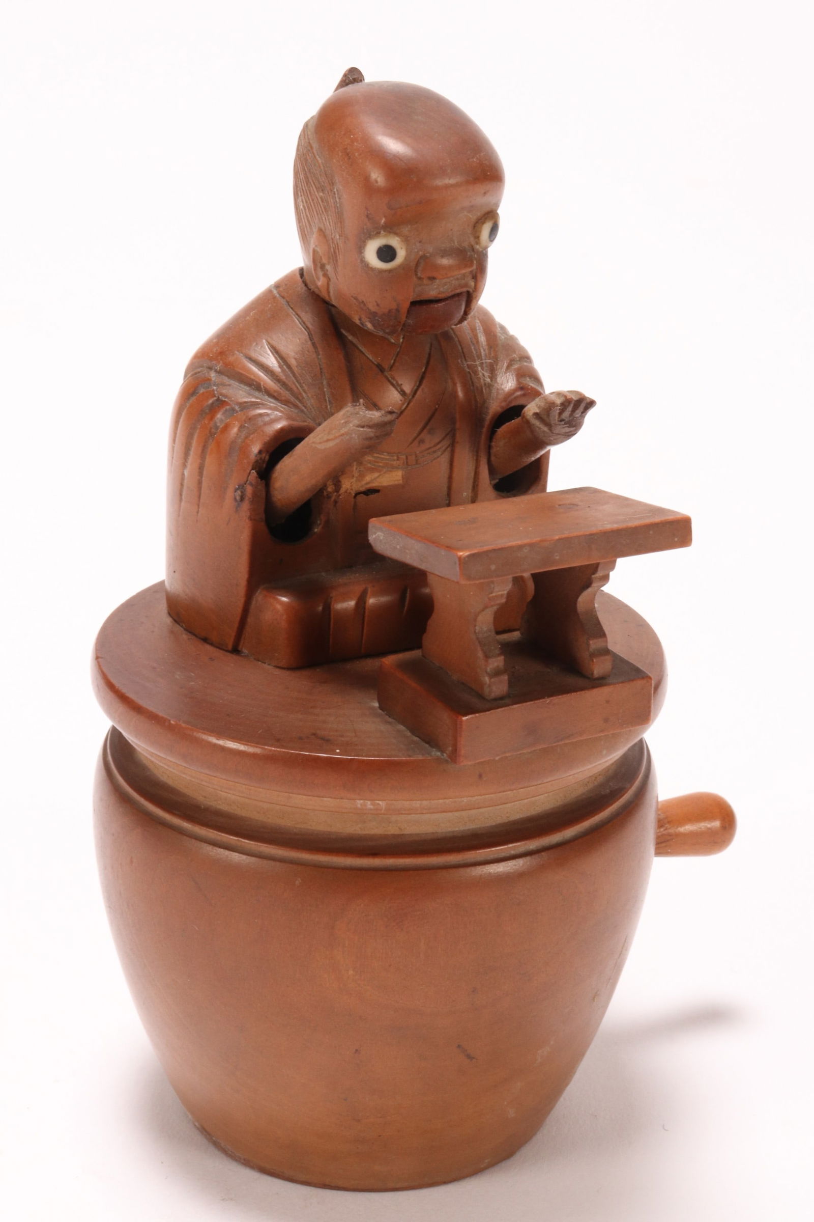 Japanese Meiji Period Kobe Automaton Toy,: in boxwood, in the form of a figure with small stand in front, with articulated limbs and head, raised on a drum shaped base, a/f (one hand broken/missing implement), height 11.5cm, Provenance: Privat