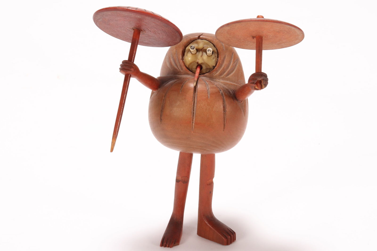 Japanese Meiji Period Kobe Daruma Toy,: in boxwood with protruding eyes and tongue, depicted wearing a cloak and holding an umbrella in both hands, height 11cm, Provenance: Private Collection of the Late Derek Greengrass, Antique Dealer