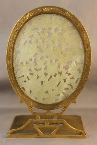 Chinese Republic Brass and Jade Panel,: of oval form carved with birds and flower heads, supported on a character base, h 17cm Provenance: Jimmy Zhu Collection