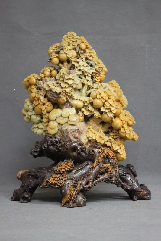 Large Chinese Carved Soapstone Scene,: finely carved in the form of a large tree with hanging fruit and squirrels above a rocky outcrop, with lingzhi, h 41cm
