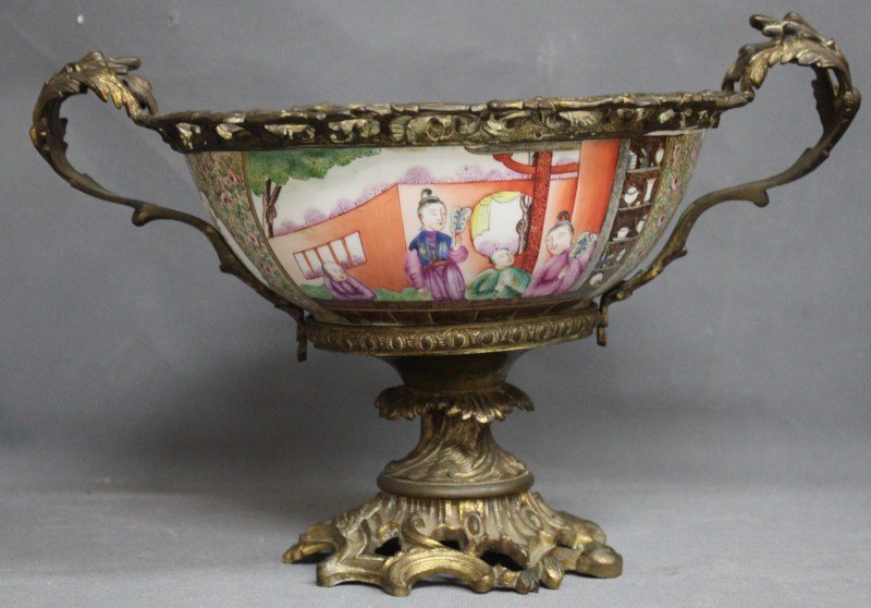 Chinese Export Porcelain and Ormolu Twin: Handled Comport, the bowl of deep tapering form, painted with figures within a landscape, and panels of flowers, flanked by a pair of acanthus handles and upper mount and supported on a rococo base, 2