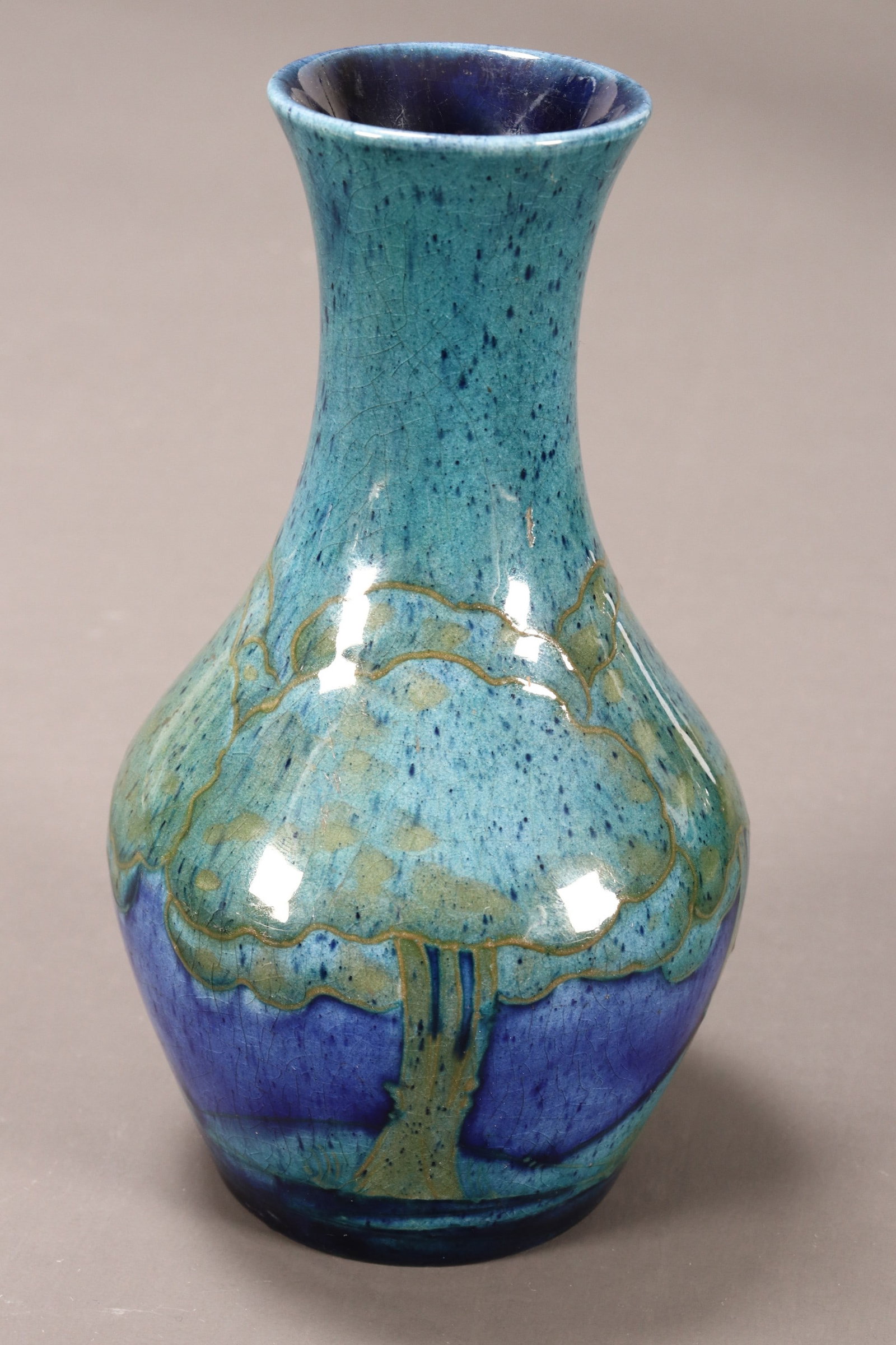 William Moorcroft 'Moonlit Blue' Pottery Vase,: of baluster form, decorated with a frieze of trees in a moonlit landscape, in mottled tones of blue and green, signature and impressed marks to base, height 15cm
