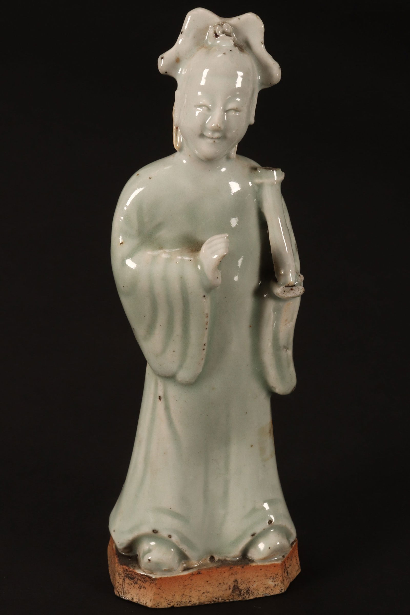 Chinese Qing Dynasty Celadon Figure,: depicting a lady with headdress and robe, holding a scroll, in tones of pale green, a/f, height 19cm