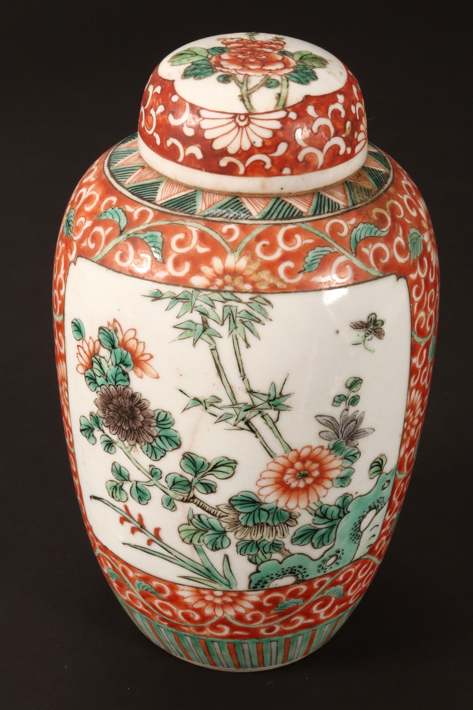 Chinese Qing Dynasty, 19th Century Porcelain Jar and Cover,: of ovoid form, decorated with reserves of flowering tree and insects, surrounded by peony scroll, in tones of green and orange, a/f, height 21cm