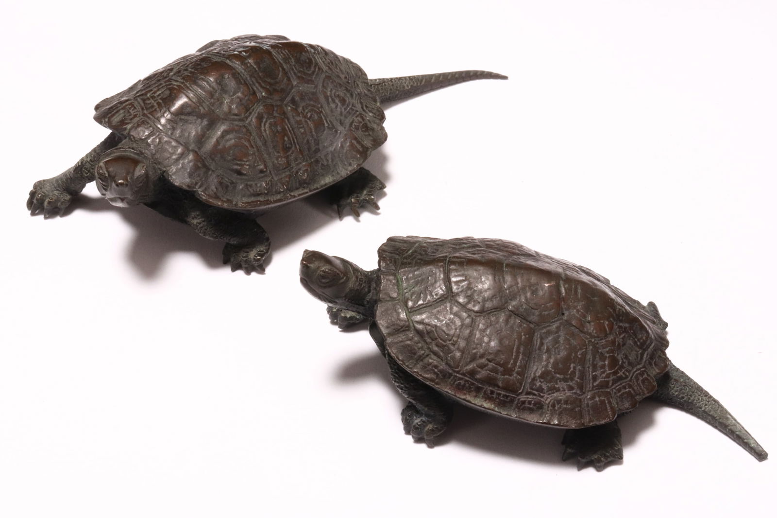 Pair of Japanese Meiji Period Bronze Okimono,: in the form of turtles, realistically modelled with textured shells, incised signature to base, a/f (damage to one tail), height 3cm and length 10cm (2)