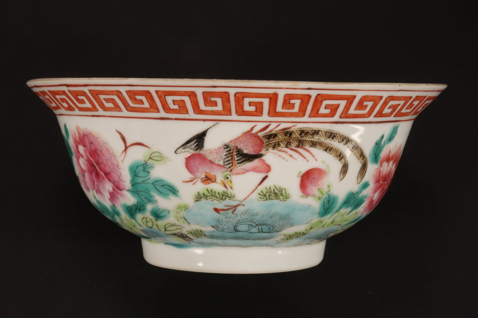 Chinese Famille Rose Porcelain Bowl,: with a spreading lip, with Greek key boarder, surrounded by a frieze displaying peonies, birds and trees, in tones of pink, green, blue and orange, on circular foot, diameter 17cm