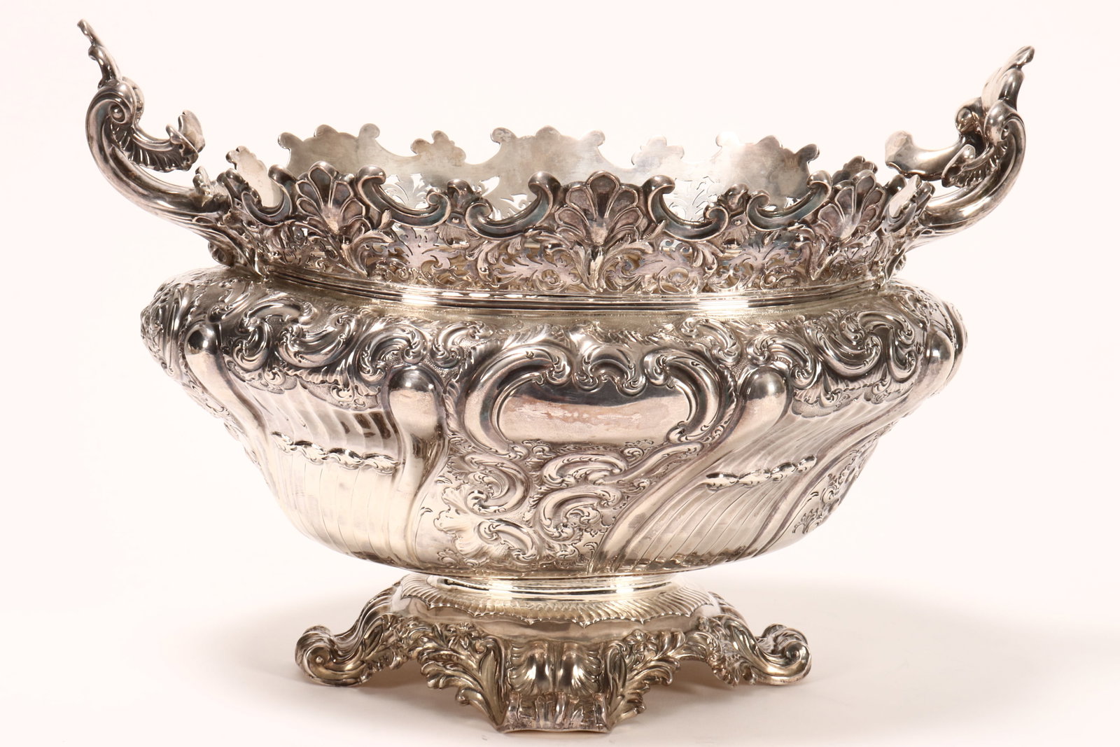 Impressive Victorian Sterling Silver Centrepiece,: hallmarked London, 1894, WS//CS (Walter & Charles Sissons), with a well cast c-scroll and shell accented rim above pierced acanthus gallery, flanked by two heavy acanthus handles, above a squat body e