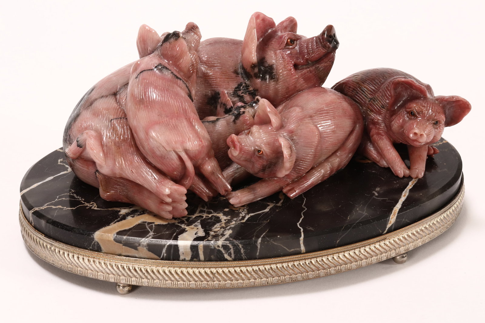 Wonderful Russian Carved Rhodonite Figure Group,: marked 84 and incised Nikolay Kulikov in Cyrillic to base, beautifully carved in the form of a sow with piglets, in tones of pink and black, set with glass eyes, on an oval marble base with silver sur