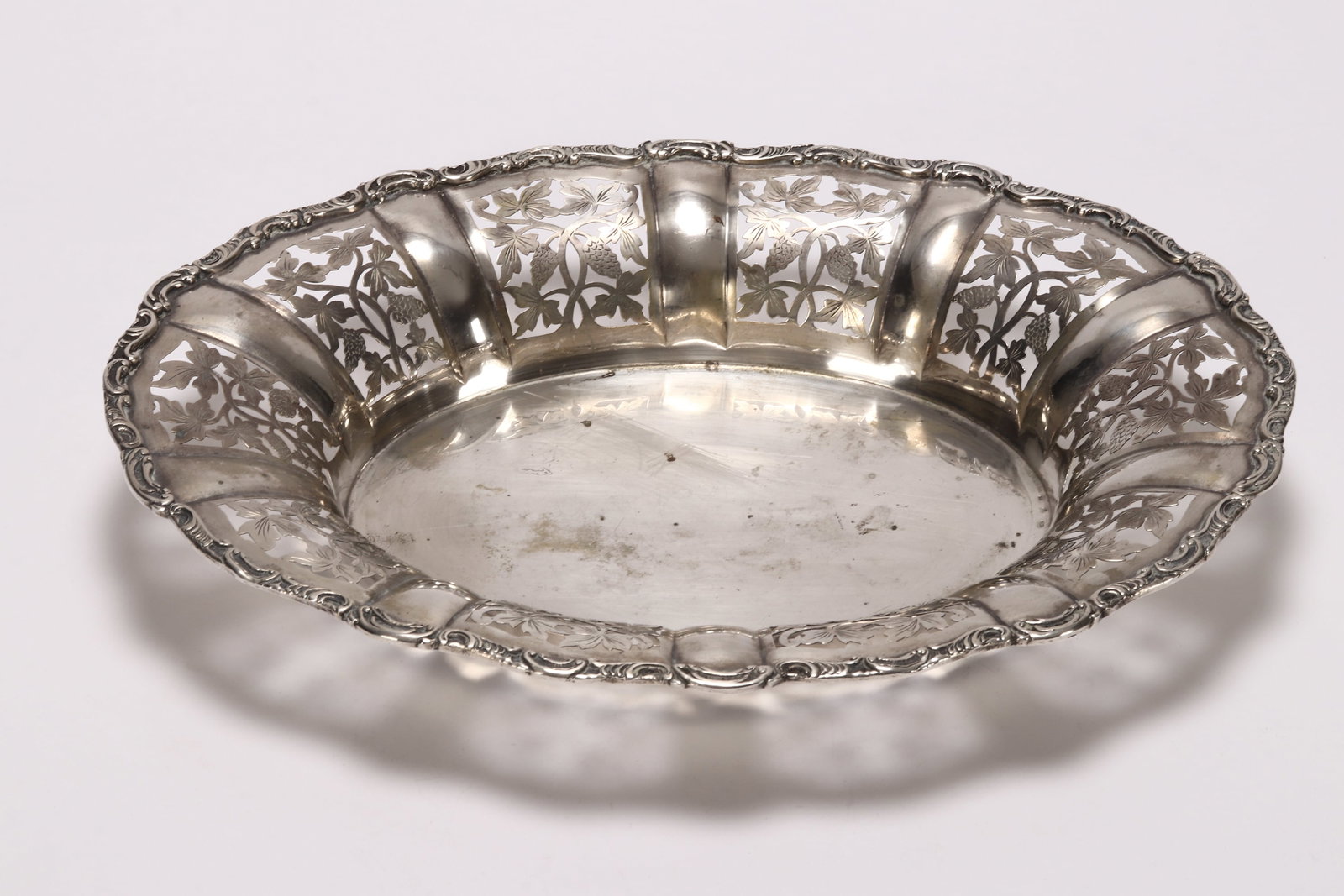 Austrian Pierced Silver Bowl,: marked 800, Vienna, J.H, of oval form, with pierced panels depicting foliage and fruit, with cast acanthus border, total weight 524g, diameter 34.5cm