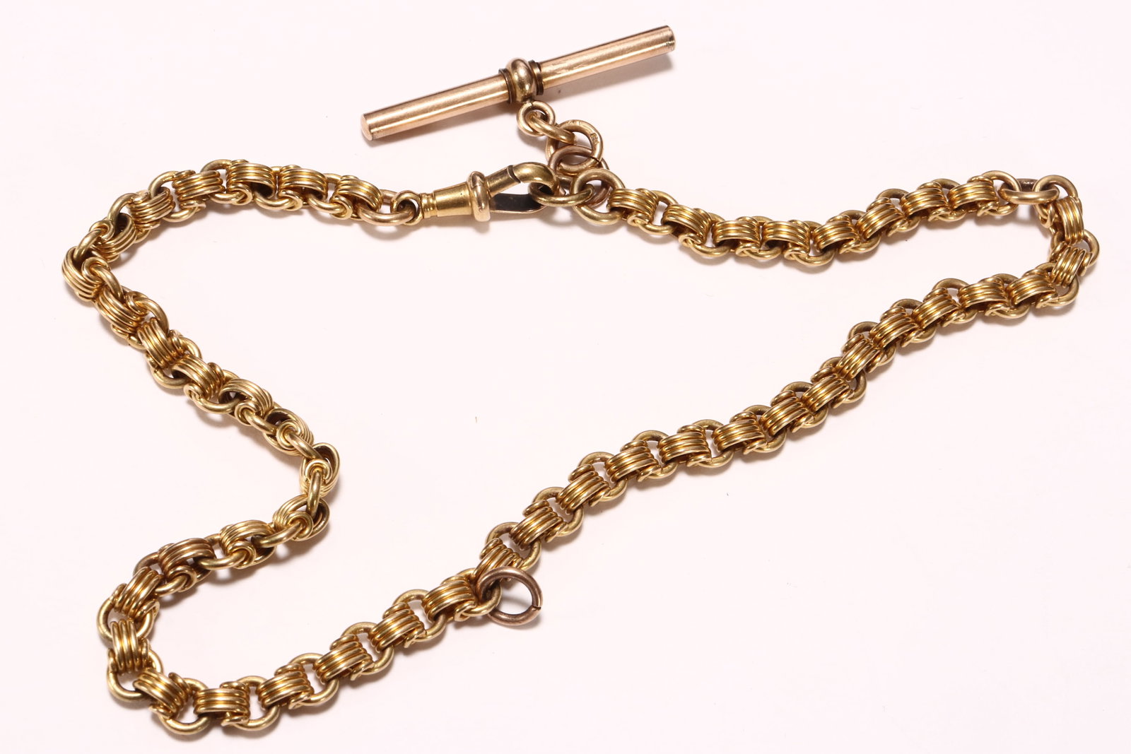 Victorian 15ct Gold Watch Chain with T-Bar,: stamped 15, in triple cable link, with T-bar pendant and Albert swivel, plus two ring bails for further appendage attachment, total weight 32.5g, total length 36.5cm includes valuation certificate dat