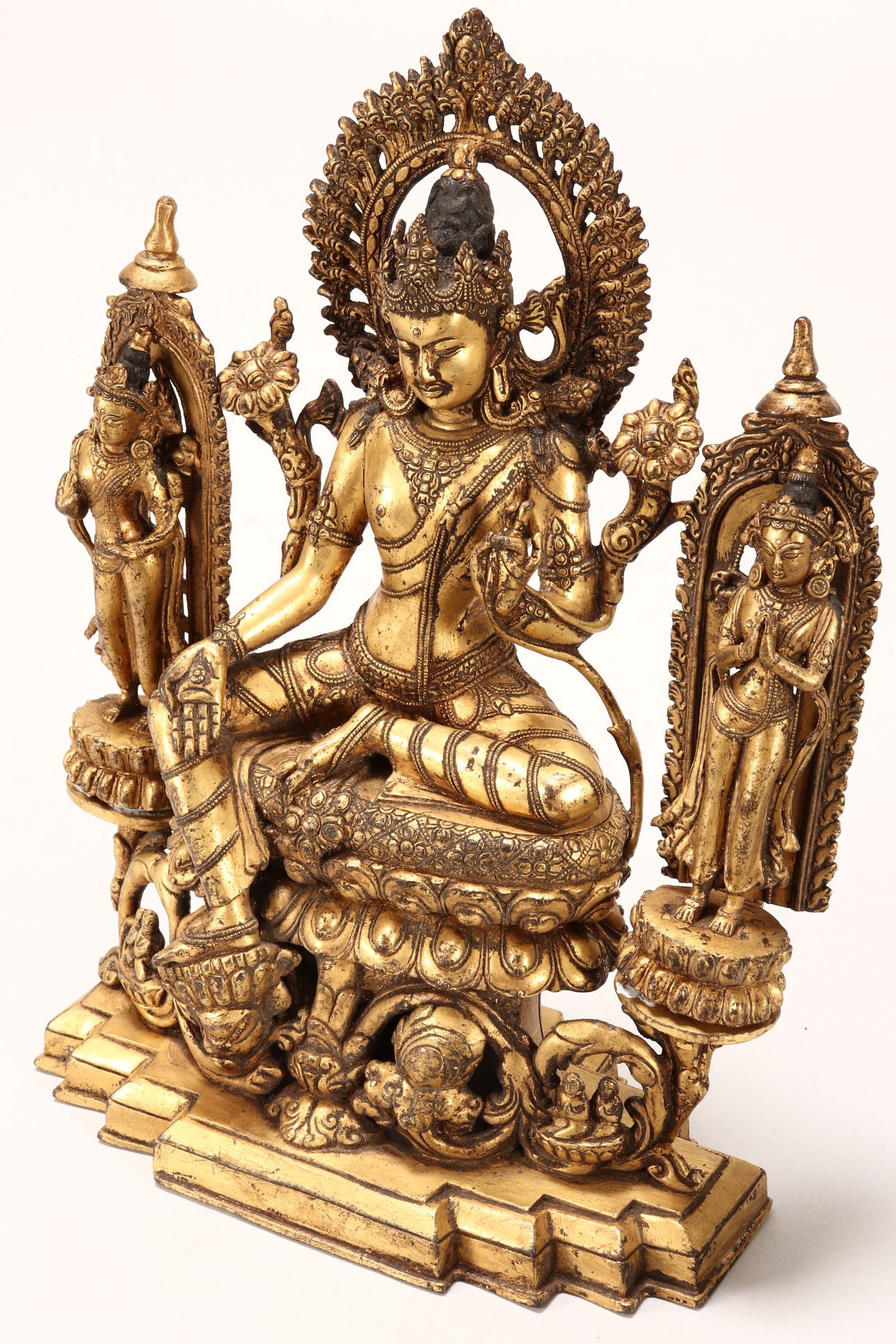 Sino-Tibetan Gilt Bronze Tara,: depicted seated, flanked by a standing tara, raised on a lotus base, height 22cm