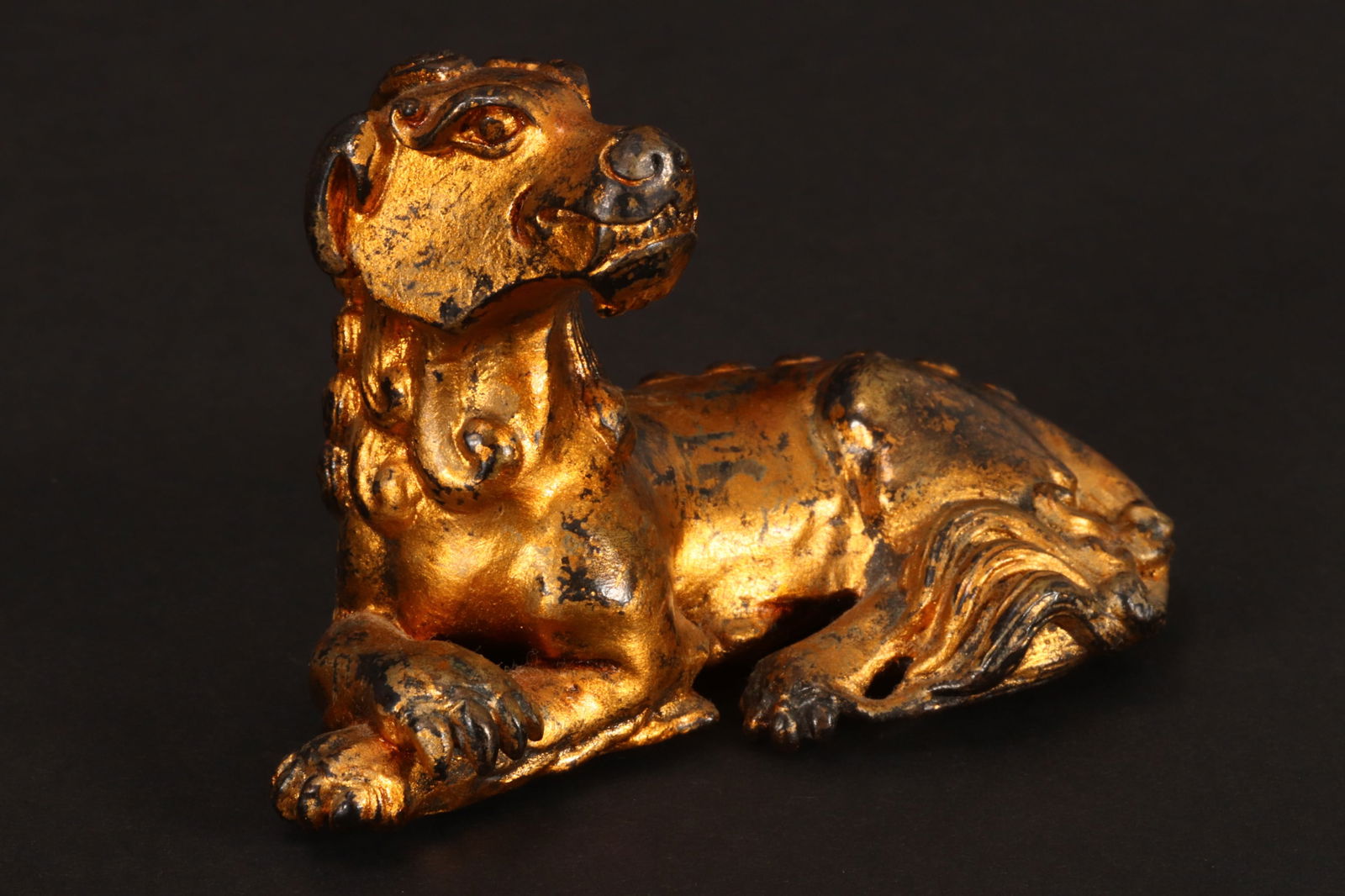 Chinese Late Qing Dynasty Gilt Bronze Scroll Weight,: in the form of a reclining stylised dog, length 7cm
