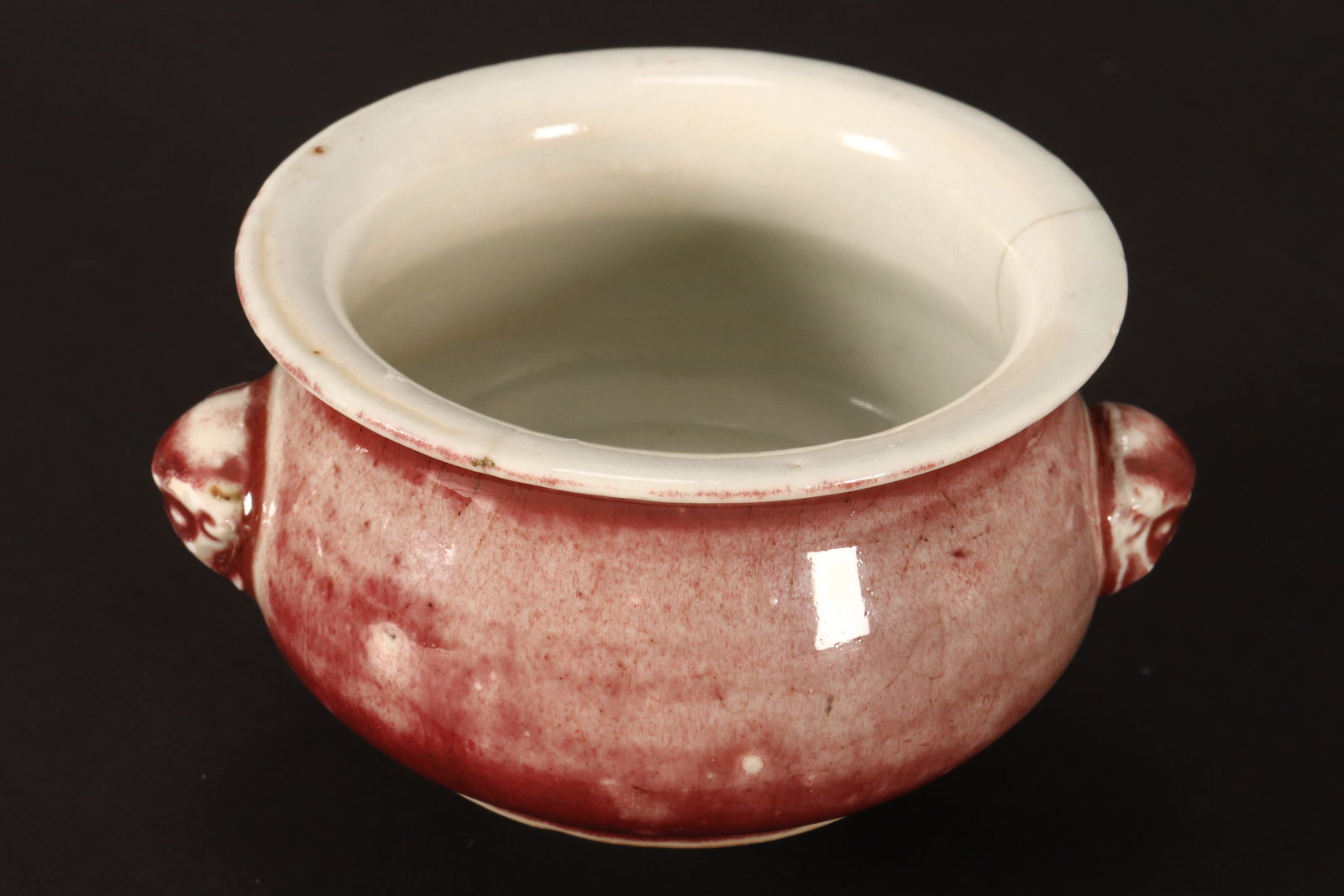 Chinese Qing Dynasty Mottled Sang de Boeuf Censer,: of squat form, with twin mask handles, on a circular foot, a/f, diameter 12cm