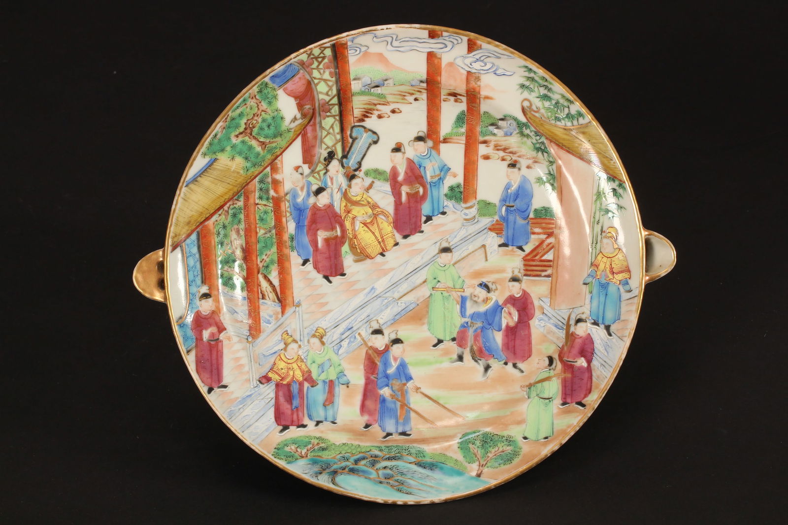 Cantonese Qing Dynasty Porcelain Warmer,: of circular form, with spouts to each side, the top decorated with court figures, attendants and warriors, in tones of pink, green, blue, orange and yellow, length 28cm