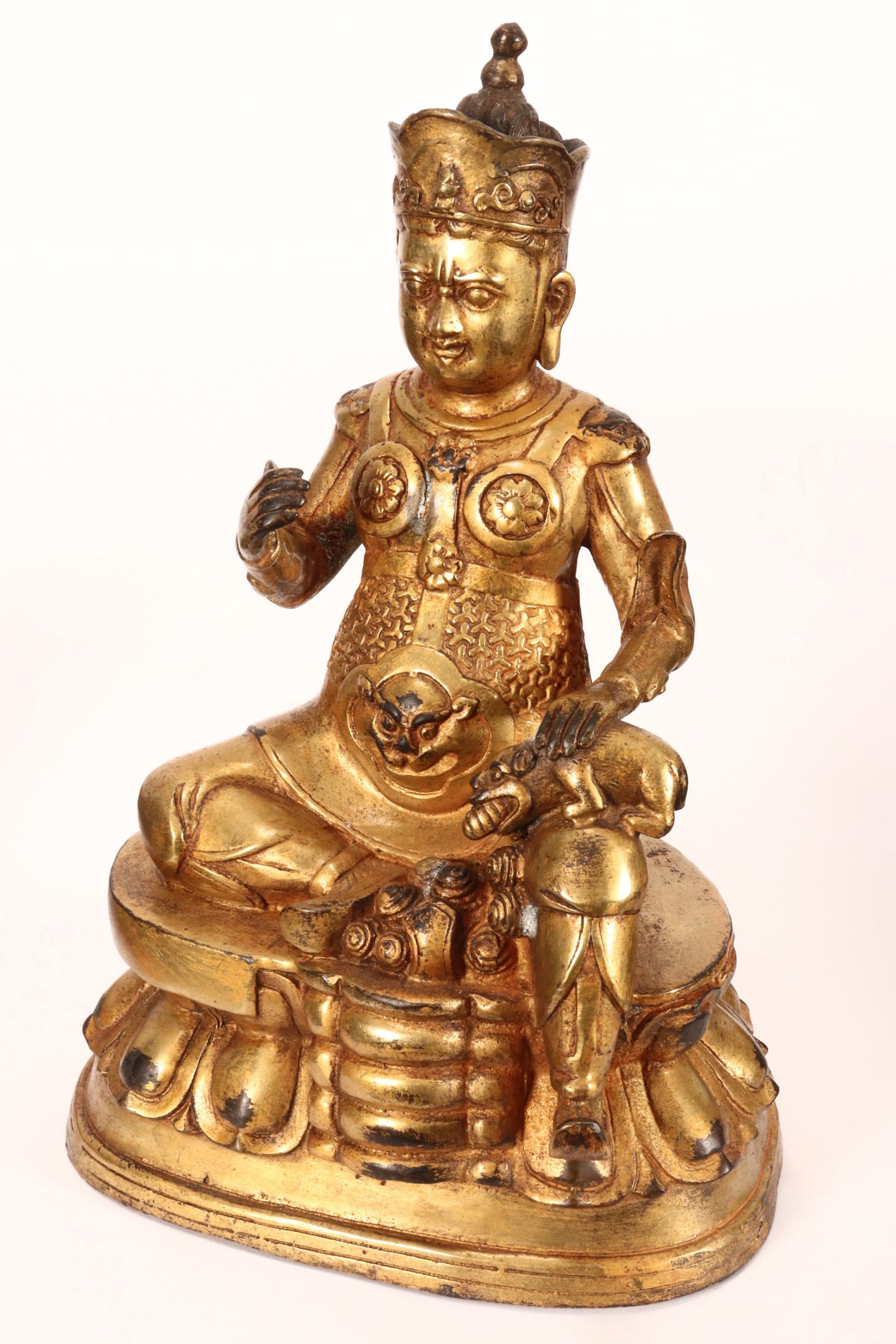 Chinese Gilt Bronze Vaisravana,: depicted seated with wearing crown and amour, with mongoose seated on knee producing jewels, the whole on lotus base, a/f, height 26cm