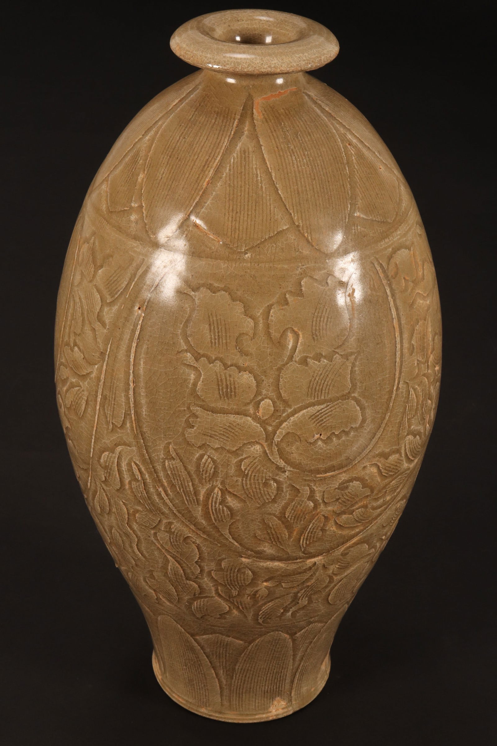 Good Chinese Yaozhou Celadon Vase,: possibly Song Dynasty, of ovoid form with a spreading lip, the body carved with lotus scroll, in an olive green glaze, raised on a circular foot, height 29.5cm