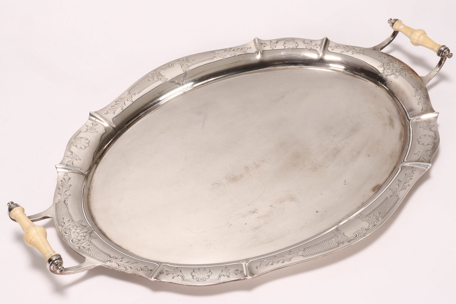 Impressive George VI Sterling Silver Twin Handled Tray,: hallmarked London, 1939, Adie Bros., of shaped oval form decorated with engraved rocaille border, with turned handles terminating in acanthus to base, total weight 2978g, 64cm x 42cm