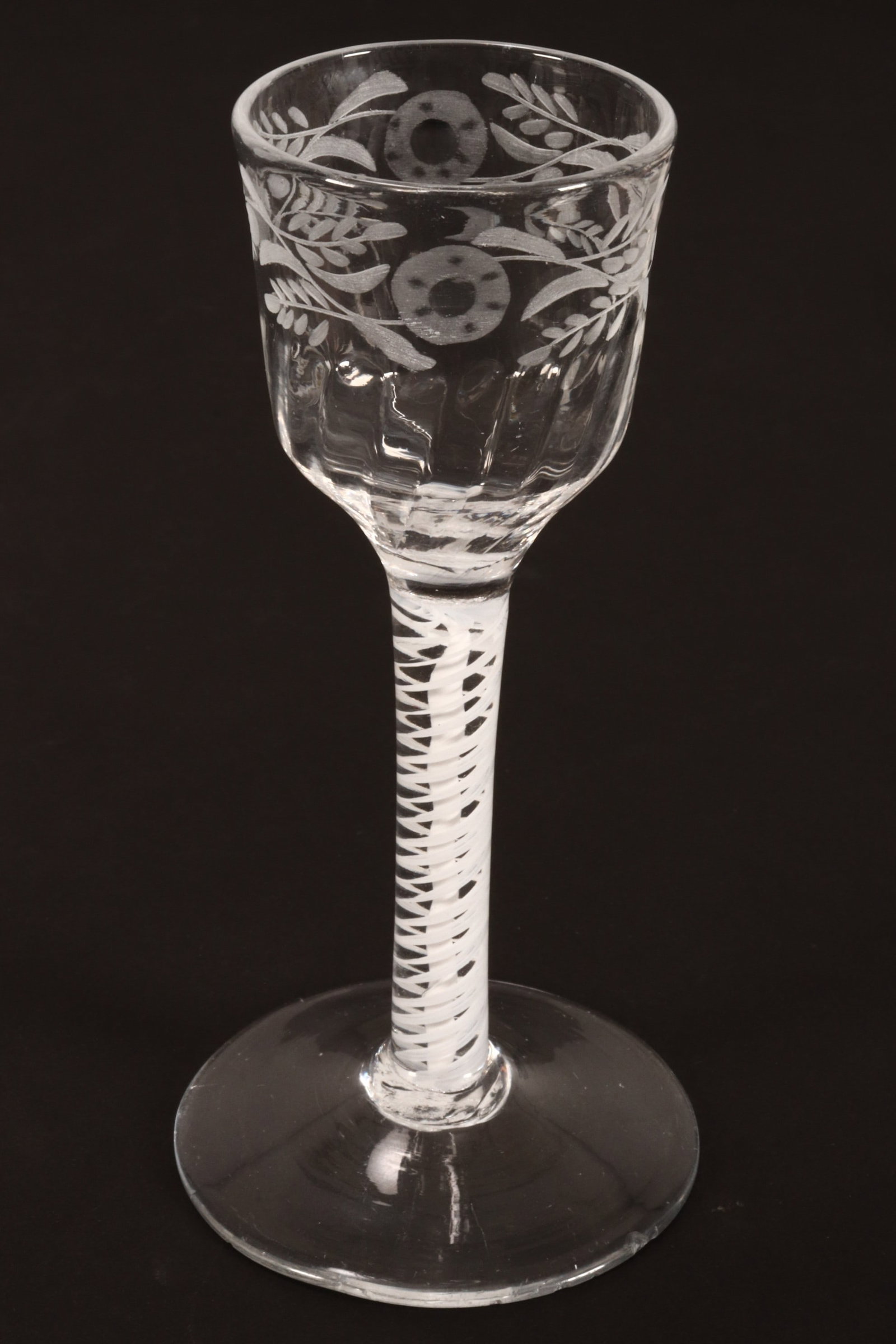 18th Century British Opaque Twist Wine Glass,: c.1760, with petalled bowl and etched floral design to lip, with central spiral and twist surround, on a conical foot, height 14.5cm