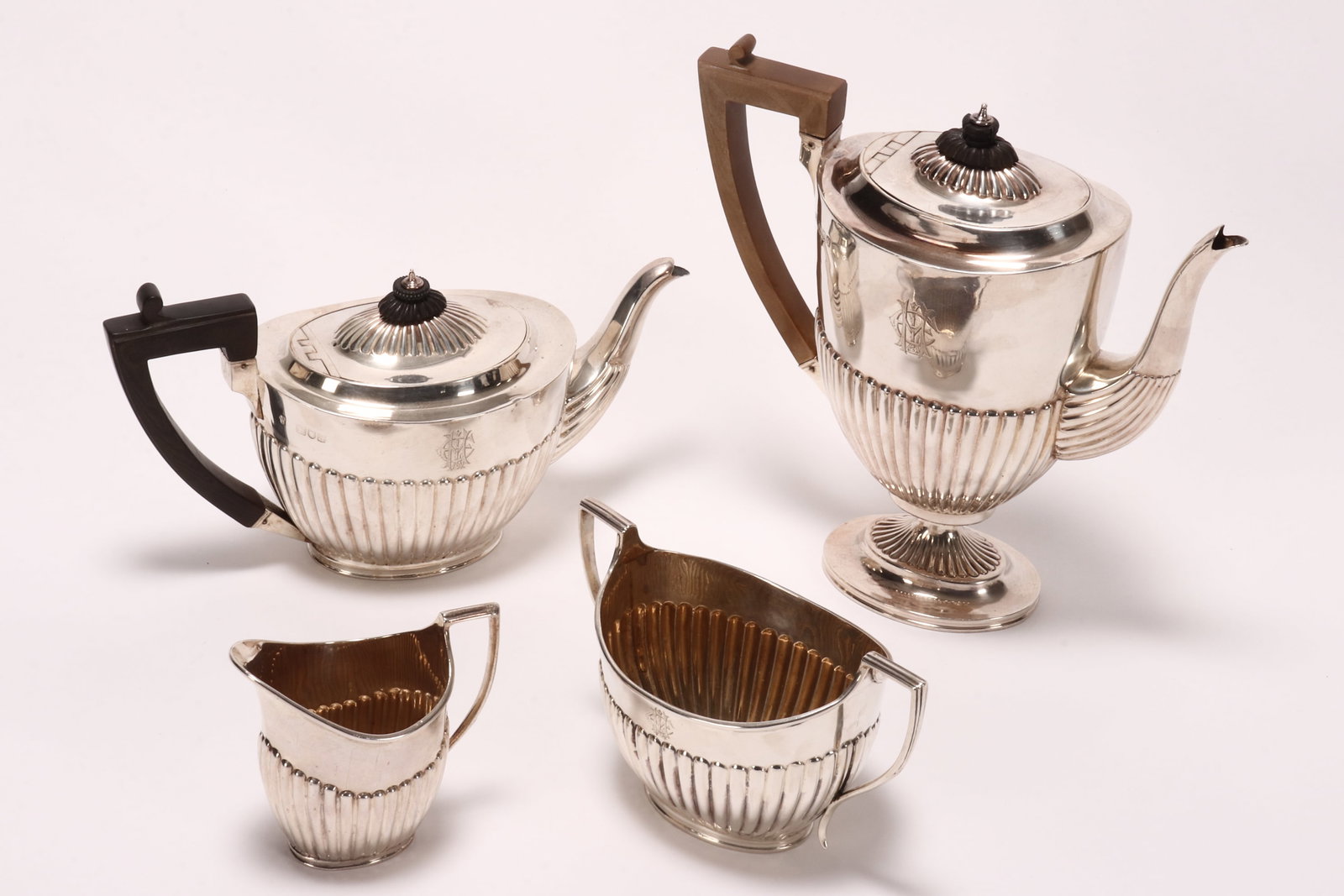 Victorian Four Piece Sterling Silver Tea Service,: hallmarked London, 1896, CSH (Charles Stuart Harris), comprising tea pot, height 14cm, coffee pot, height 23.5cm, creamer, height 9cm, and twin handled sugar pot, height 10cm, each of elliptical form,