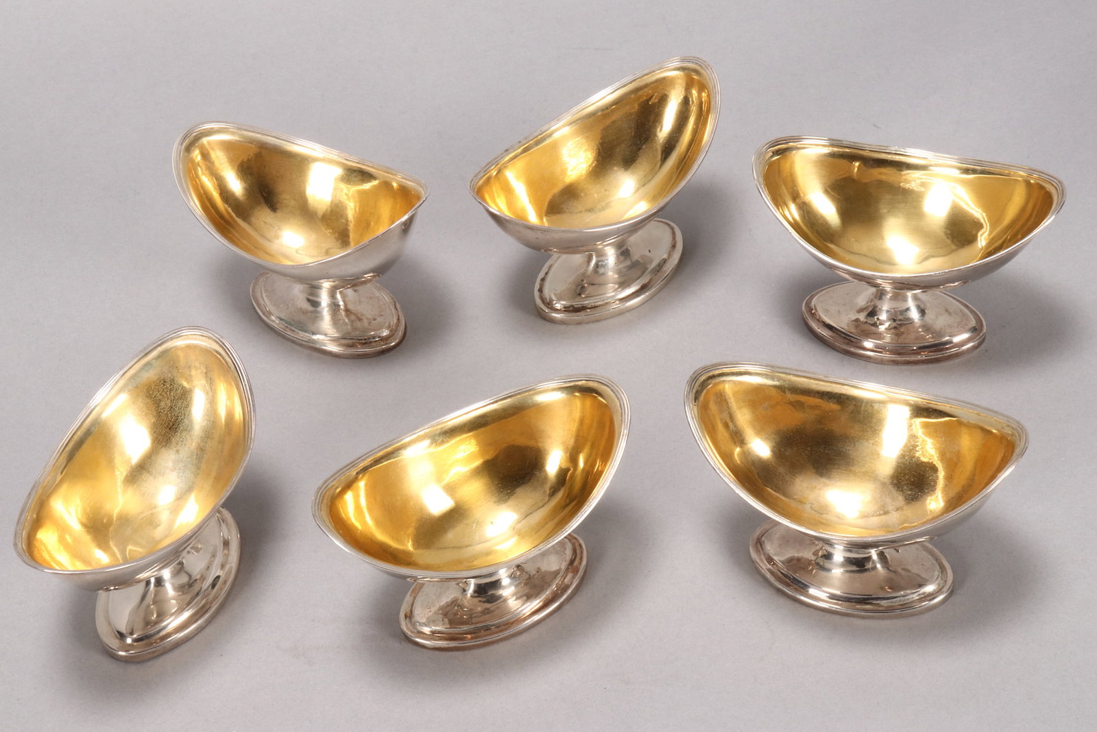Set of Six George III Sterling Silver Salts,: hallmarked London, 1797, Urquhart & Hart, of plain navette form with gilded interior, surrounded by reeded borders, on a stepped oval foot, total weight 314g, length 11cm (6) Provenance: The Estate of