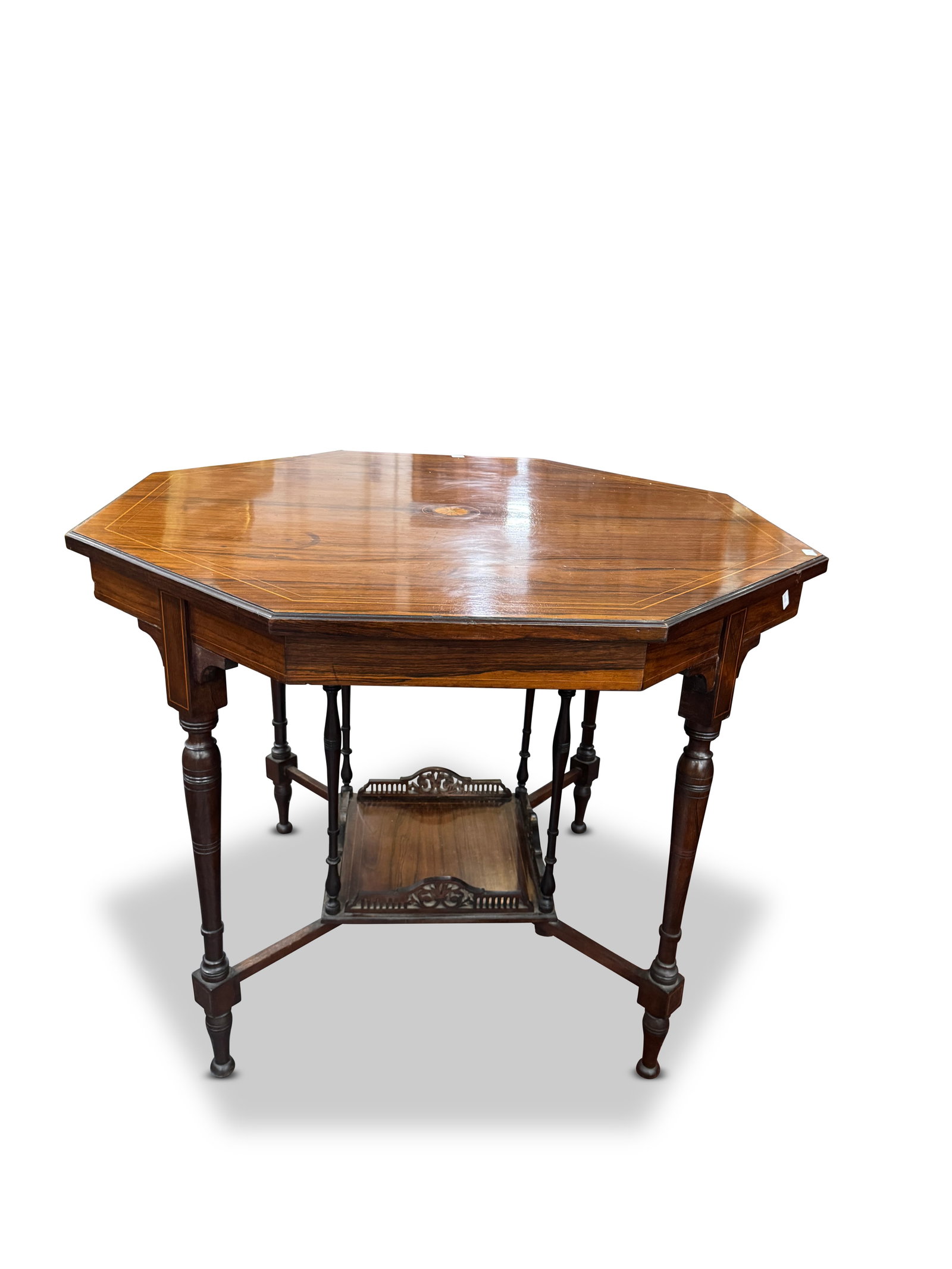 Good Edwardian Octagonal Centre Table,: with central inlaid roundel surrounded by fine stringing to the borders, on four slender legs united by a lower central gallery shelf, on bun feet, height 69cm x width 87cm
