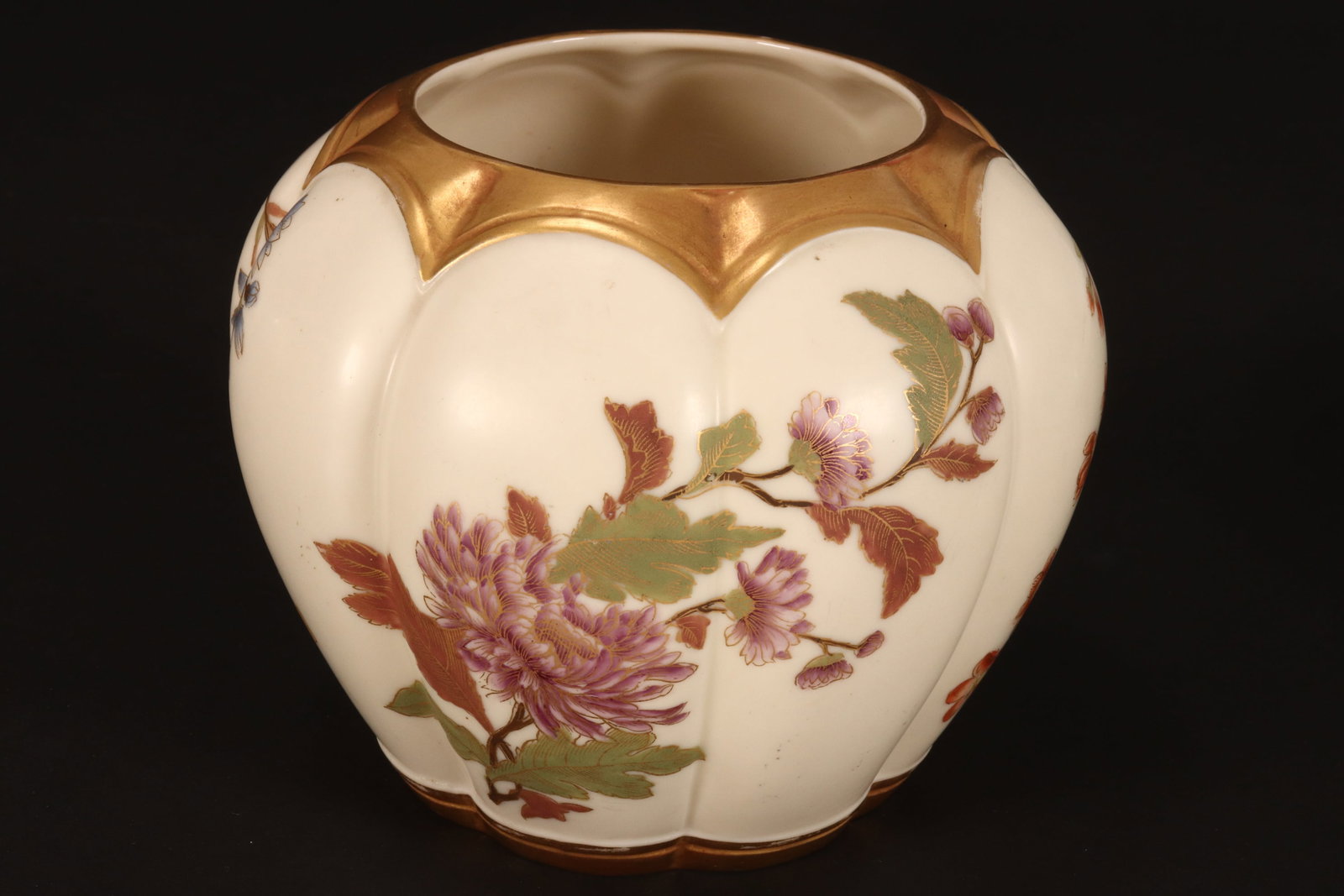 Royal Worcester Blush Ivory Porcelain Vase, c.1889,: of lobed form, decorated with floral and foliate sprays, in tones of green, purple, red and blue on an ivory ground, with gilt accents, stamped to base, height 13.5cm
