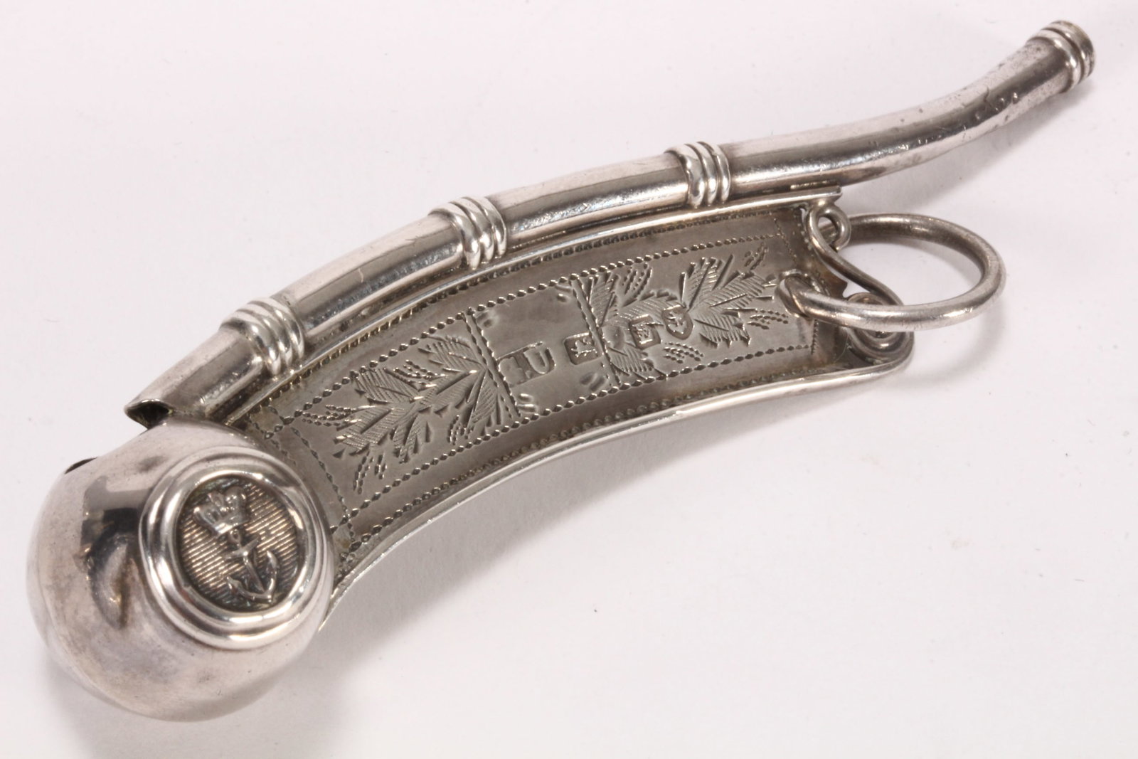 Victorian Sterling Silver Bosun's Whistle,: hallmarked Birmingham, 1852, George Unite, the pipe with reeded motifs, the barrel set with anchor and coronet motif, the flat plate decorated with engraved floral motifs, total weight 12g, length 9.5