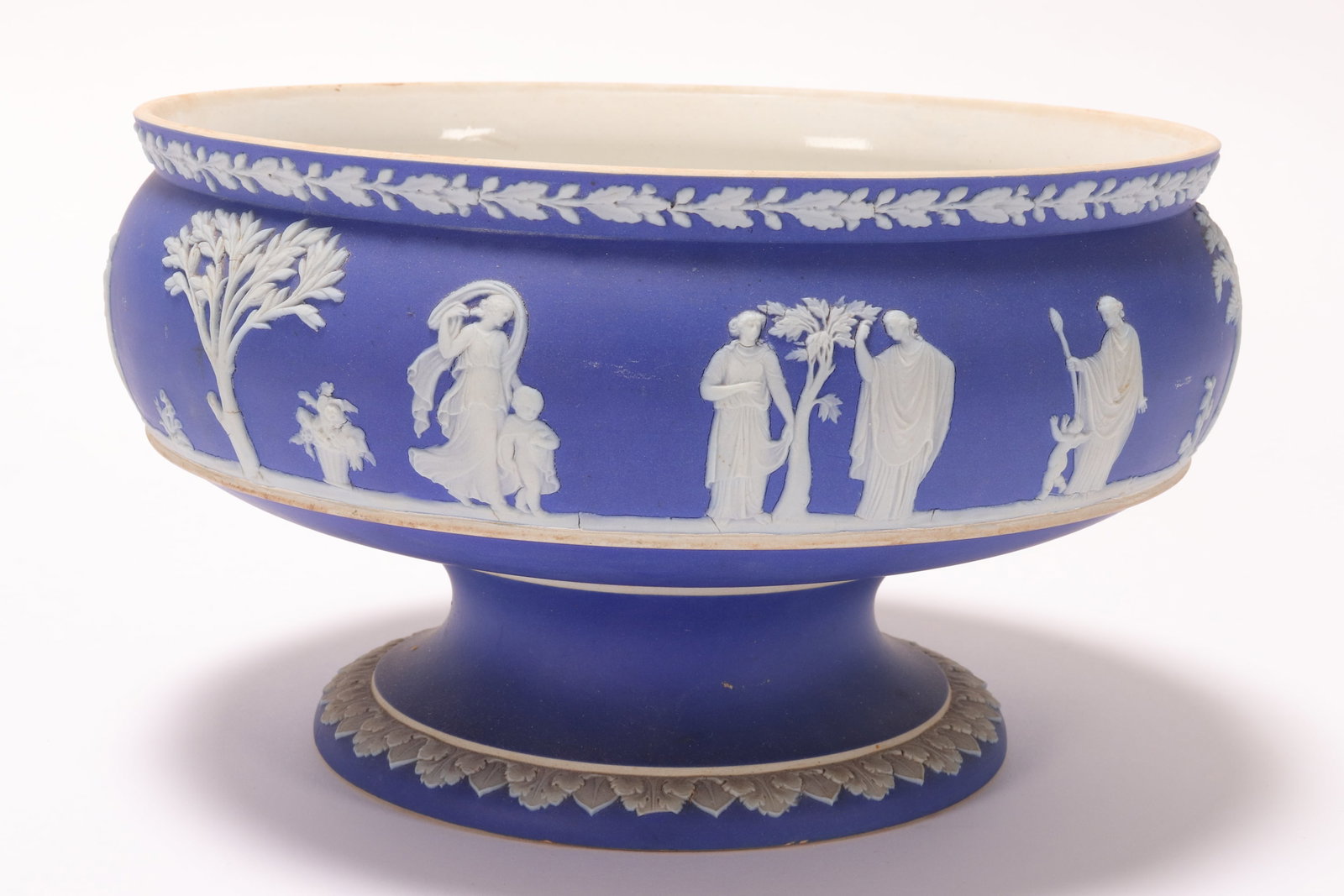 19th Century Wedgwood Jasperware Pedestal Bowl,: decorated with classical figures in a garden setting, accented with leaf and berry and foliate borders, impressed Wedgwood to base, height 13cm and diameter 23cm