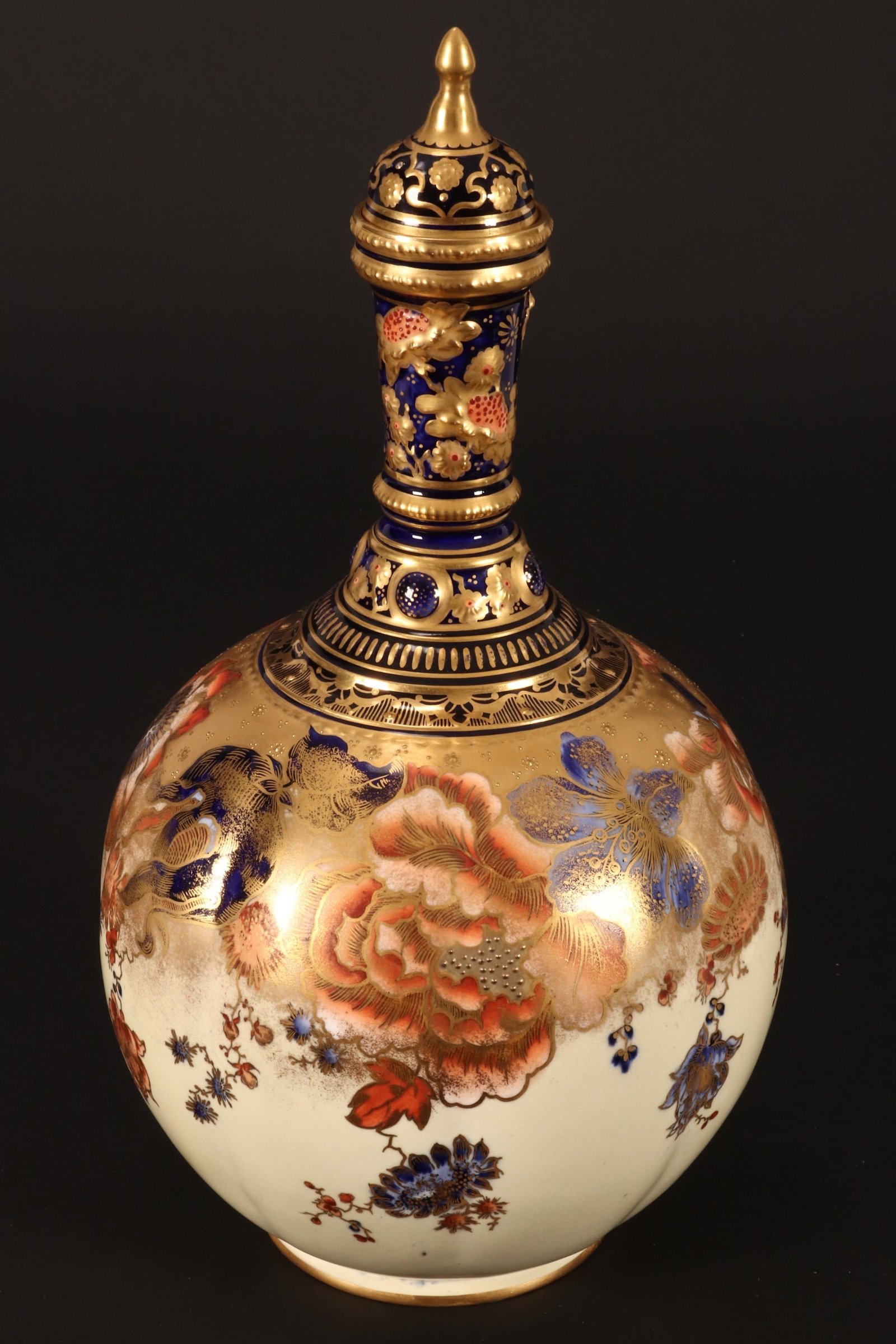 Royal Crown Derby Porcelain Bottle Vase and Cover,: with domed cover and finial, above a lobed spherical body, decorated with flowers, in tones of orange and cobalt, accented with gilt, factory mark to base, a/f to cover, height 33cm