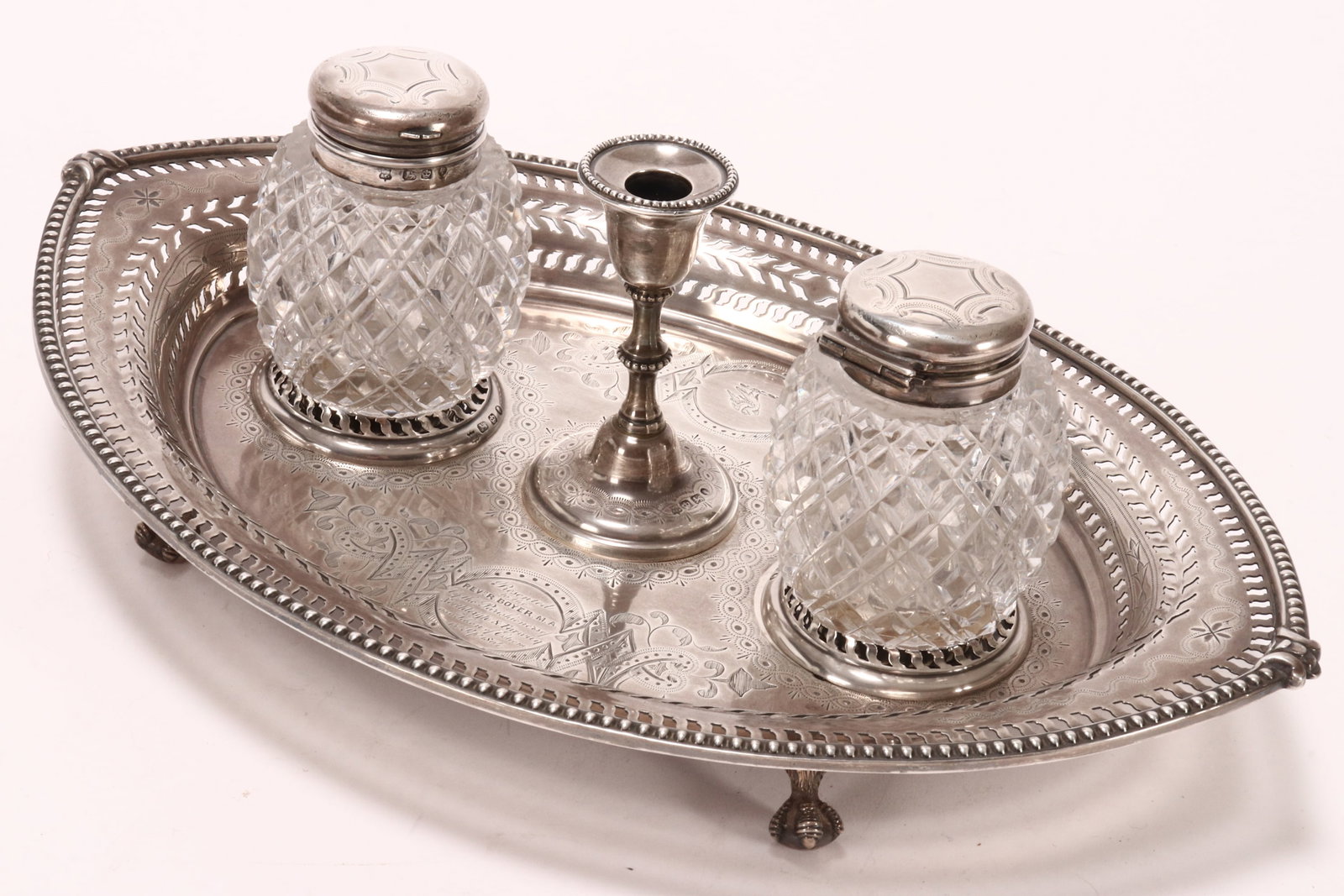 Lovely Victorian Sterling Silver Inkstand,: hallmarked Sheffield, 1862, MH//&Co (Martin, Hall & Co), the pierced ovoid form tray set with central knopped taper stick, flanked by two silver capped cut crystal ink wells, beautifully decorated wit