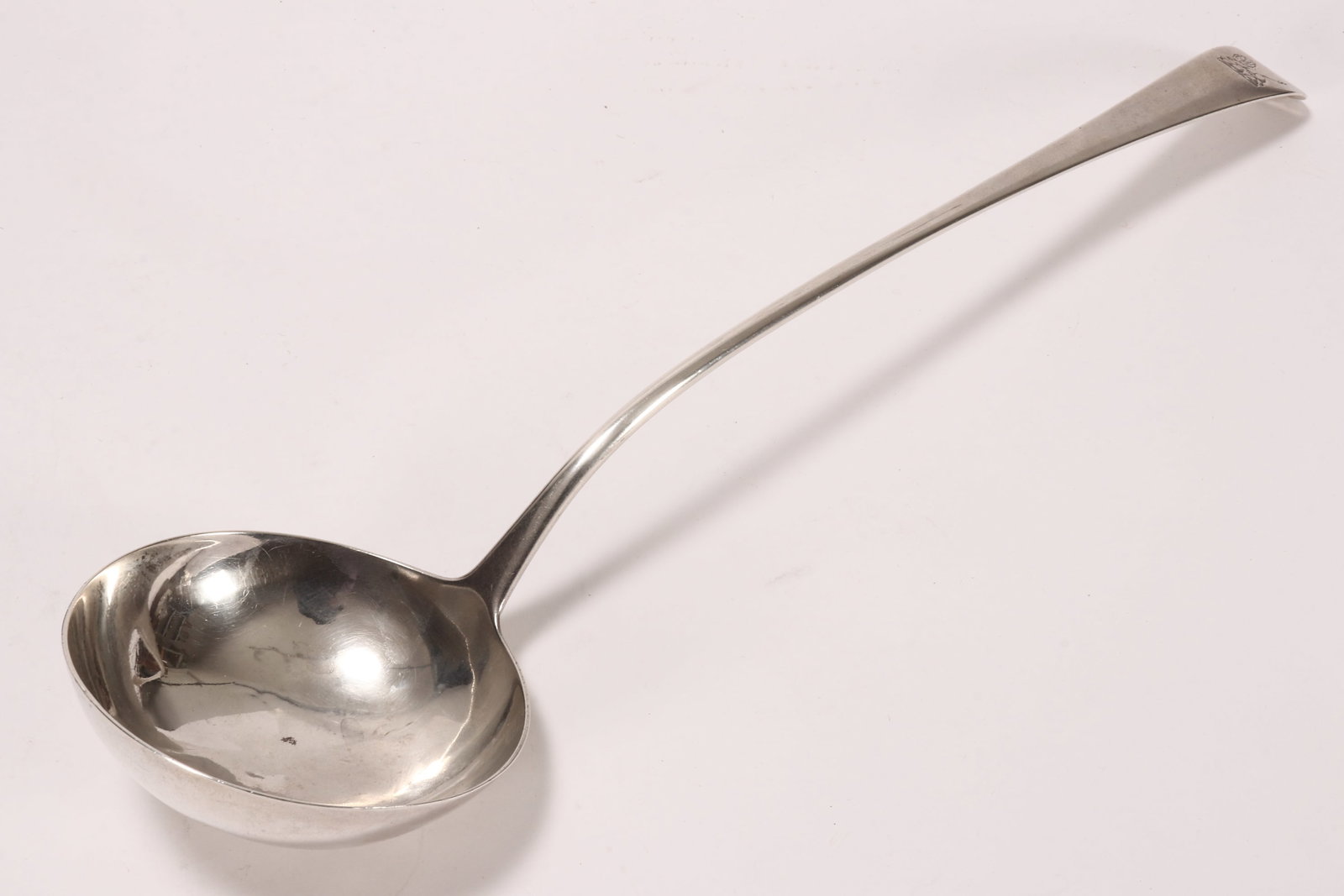 George III Sterling Silver Punch Ladle,: hallmarked London, c.1780 (date letter rubbed), W.I, in Old English pattern engraved with crest, above a deep bowl, total weight 141g, length 35cm